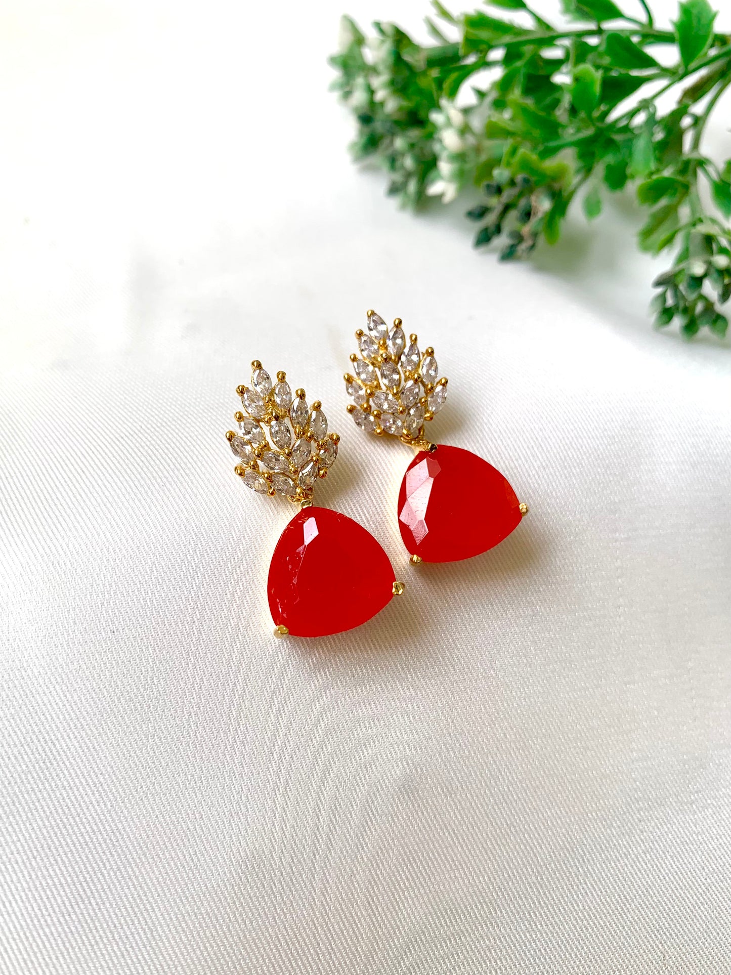 Handcrafted gold-plated designer earrings with coral stone and diamond cluster top