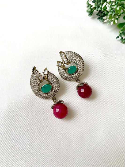 Handcrafted rhodium-plated earrings with high quality American Diamonds, semi-precious ruby and emerald stones in a Victorian finish from Zamal Jewels.