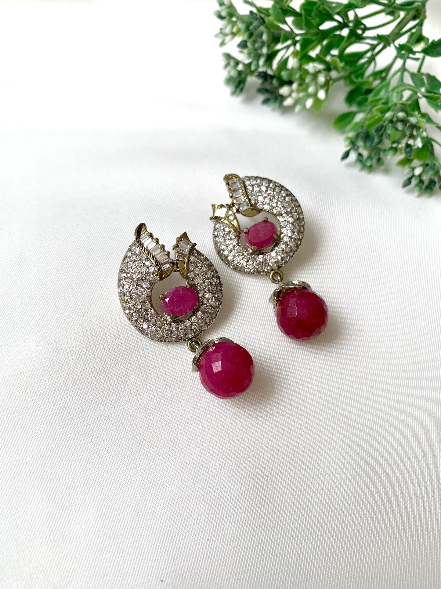 Close-up of handcrafted ruby earrings with American Diamonds in rhodium Victorian finish from Zamal Jewels