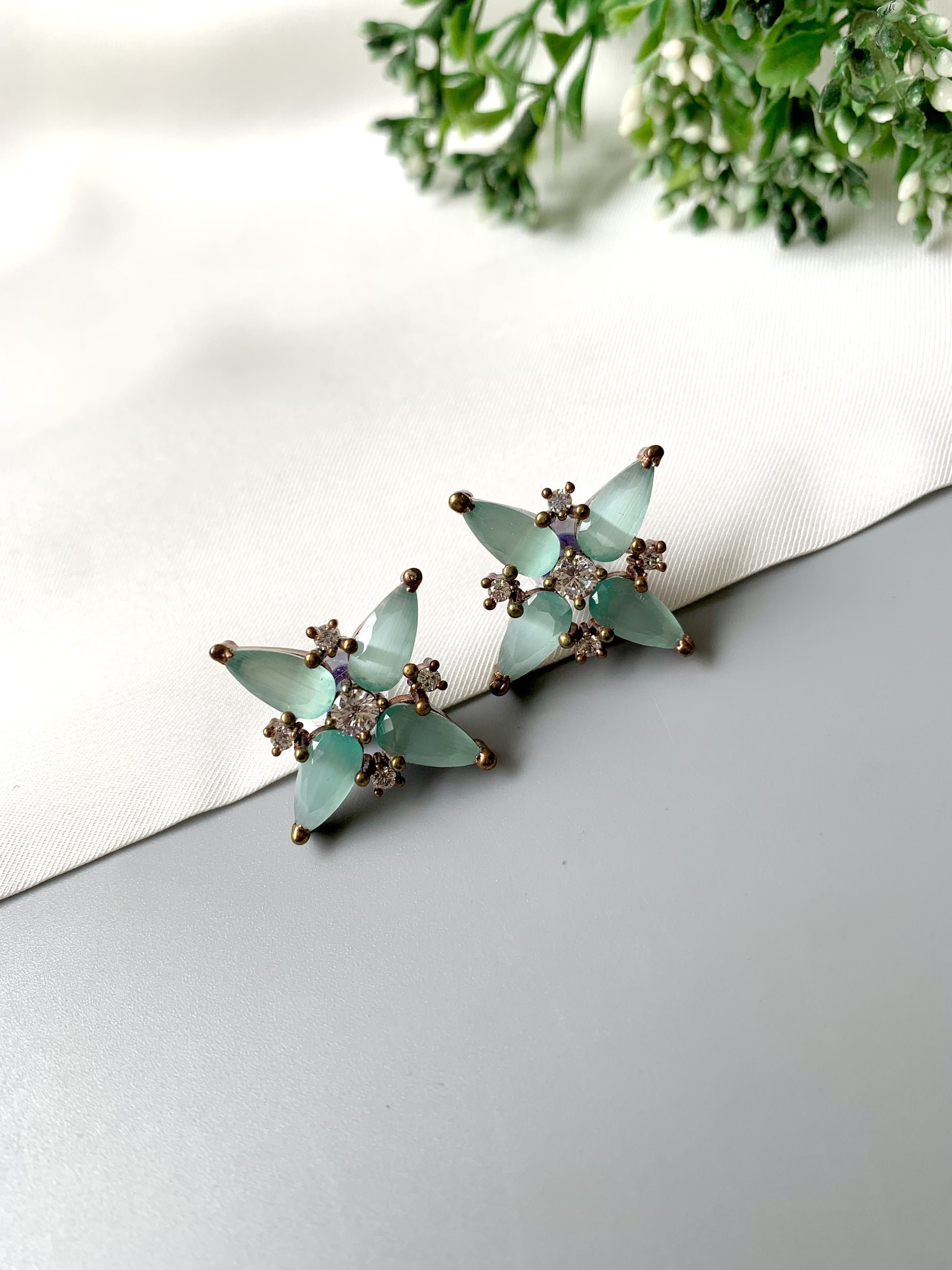 Pair of mint green onyx and diamond stud earrings – flat lay view
