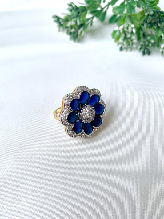 Close-up of hand-crafted floral ring with deep blue sapphire petals and American Diamonds, from Zamal Jewels
