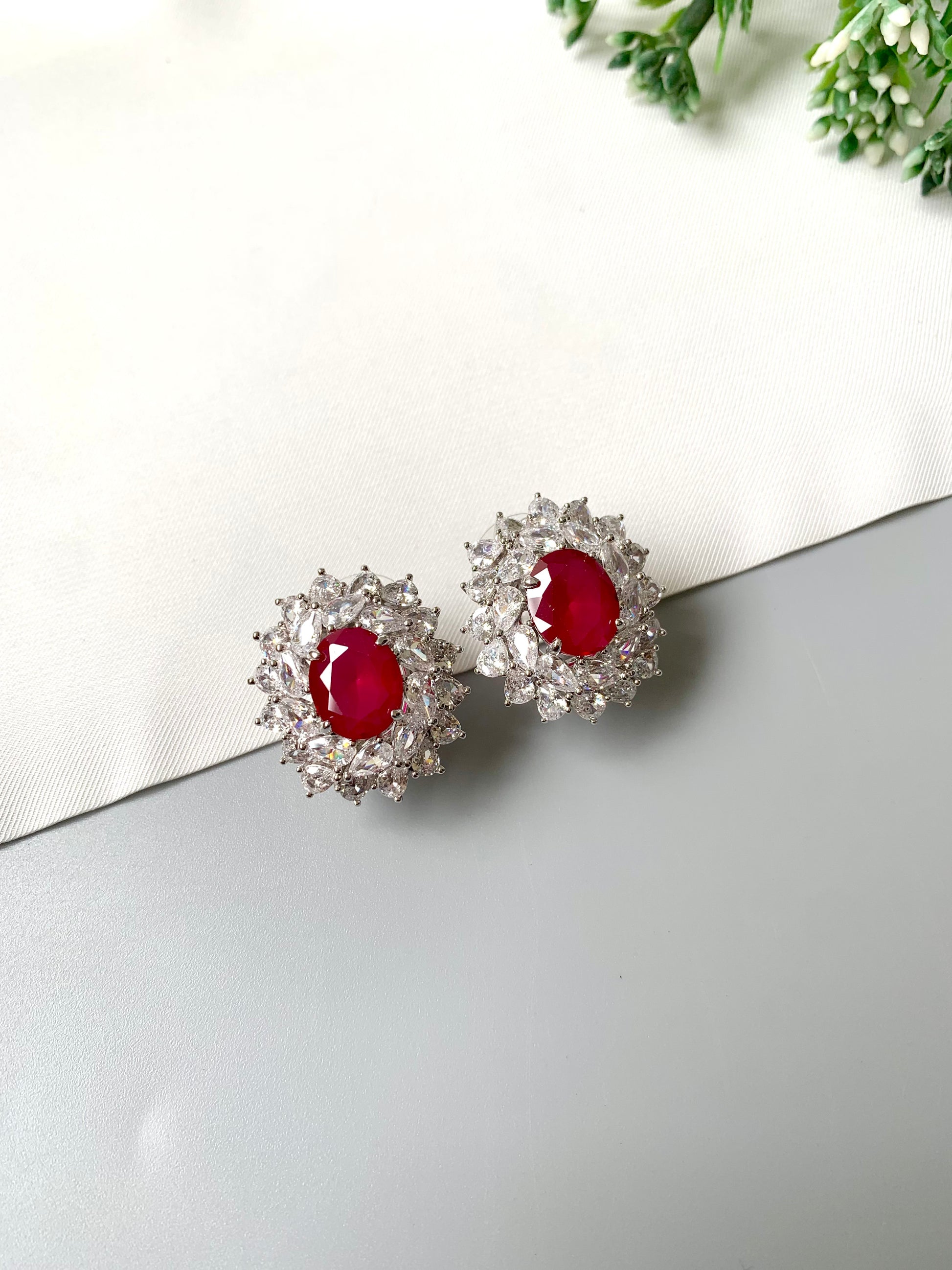 Rhodium plated hand crafted stud earrings with semi-precious ruby and American diamonds – front view