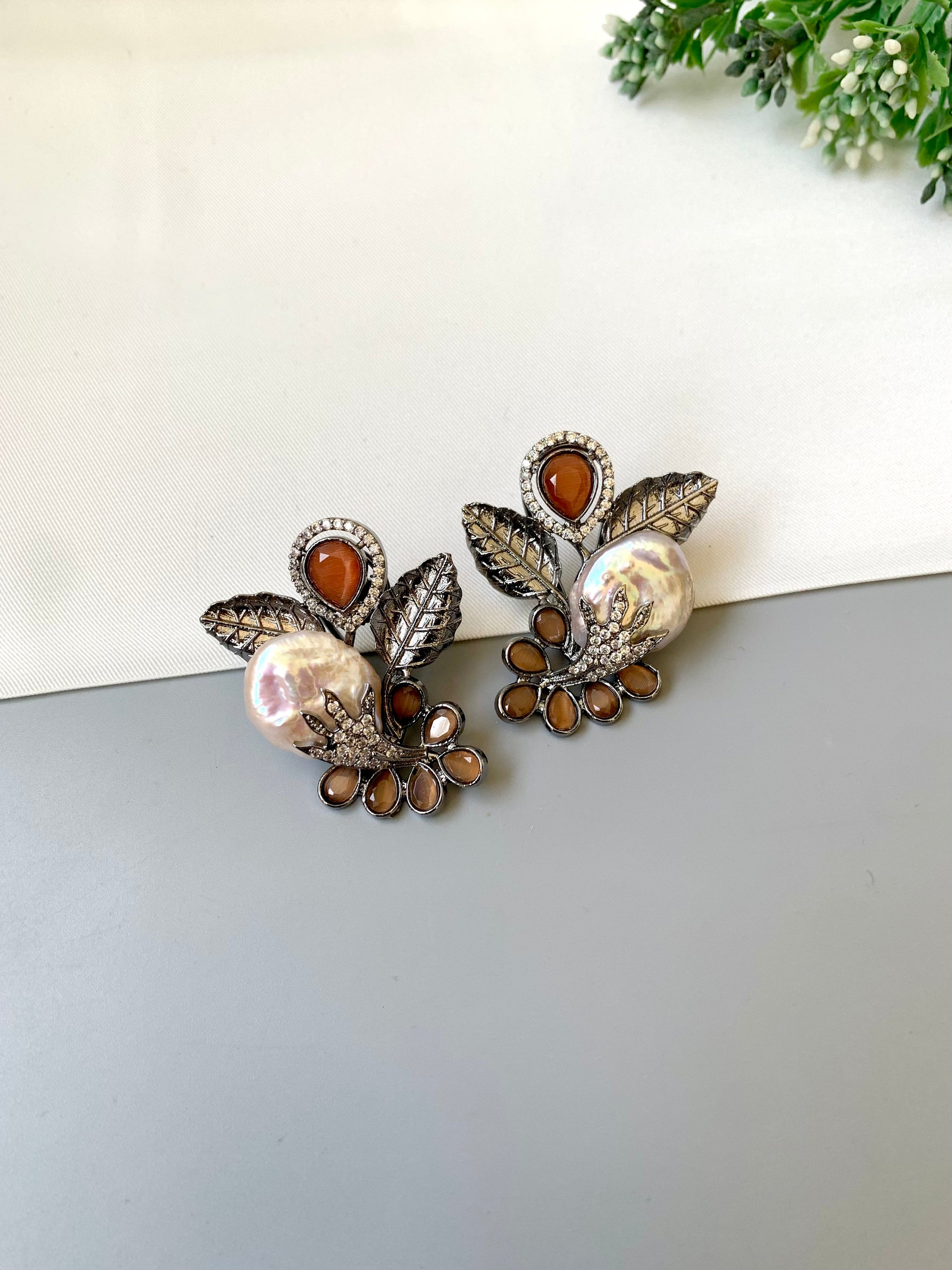 Dennis orange baroque pearl studs in rhodium oxidized finish with onyx and american diamonds