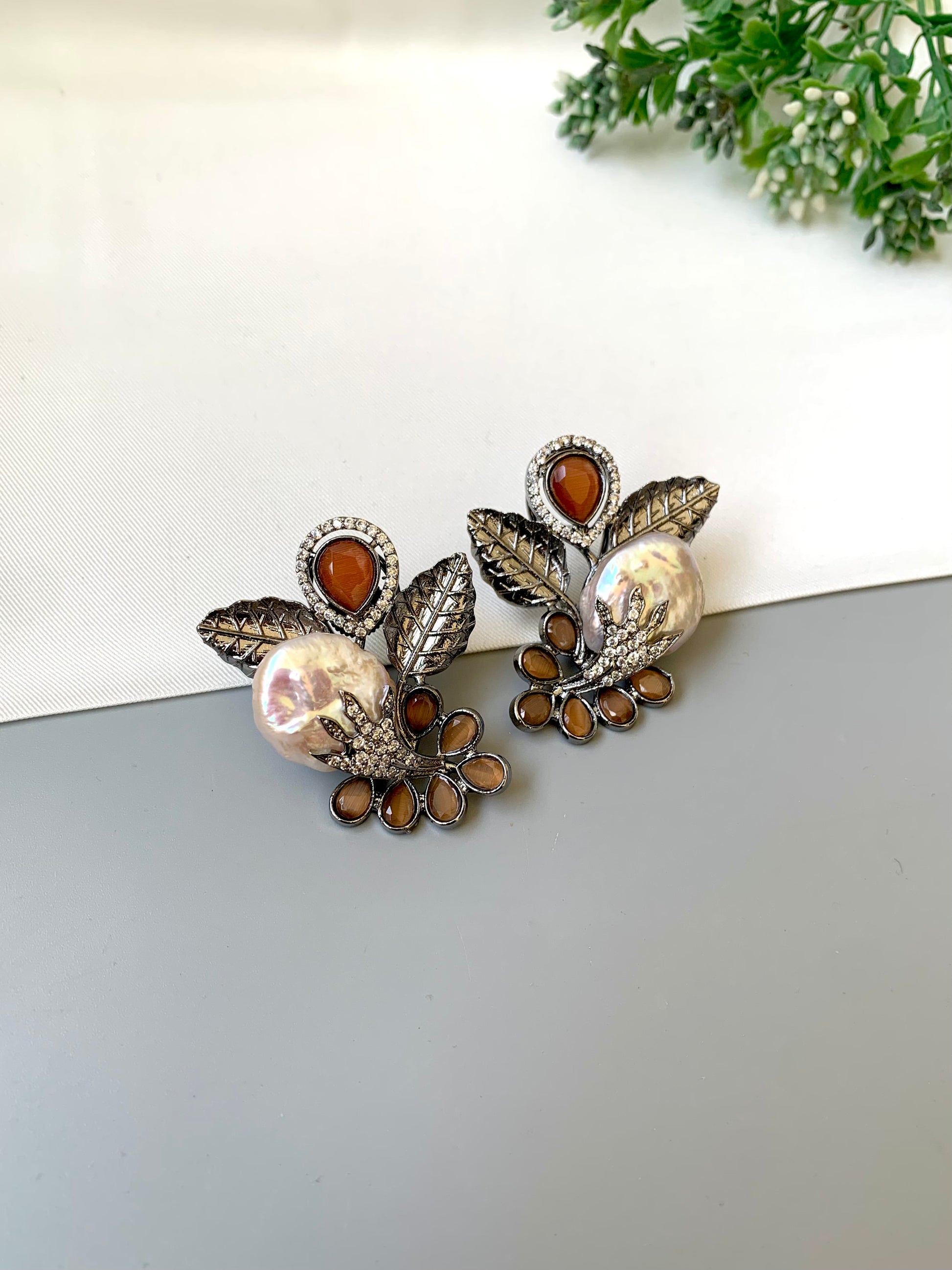 Dennis orange baroque pearl studs in rhodium oxidized finish with onyx and american diamonds