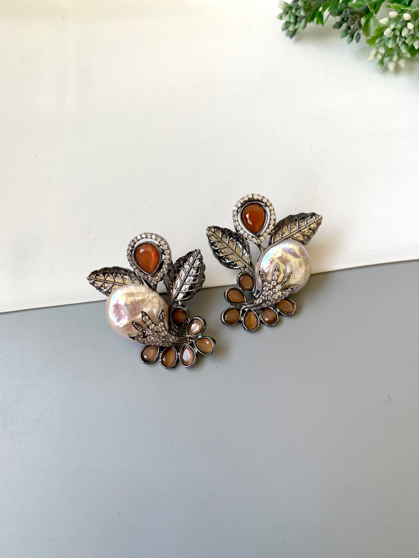 Dennis orange baroque pearl studs in rhodium oxidized finish with onyx and american diamonds