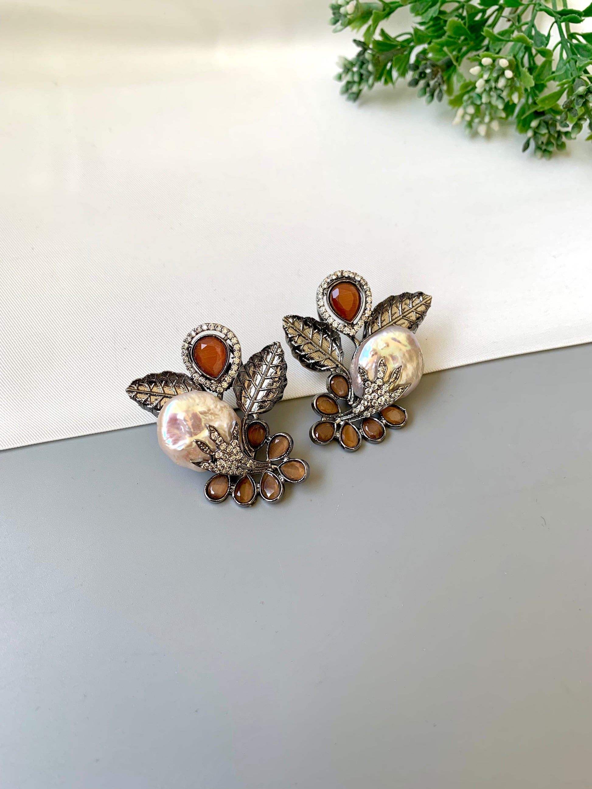 Dennis orange baroque pearl studs in rhodium oxidized finish with onyx and american diamonds
