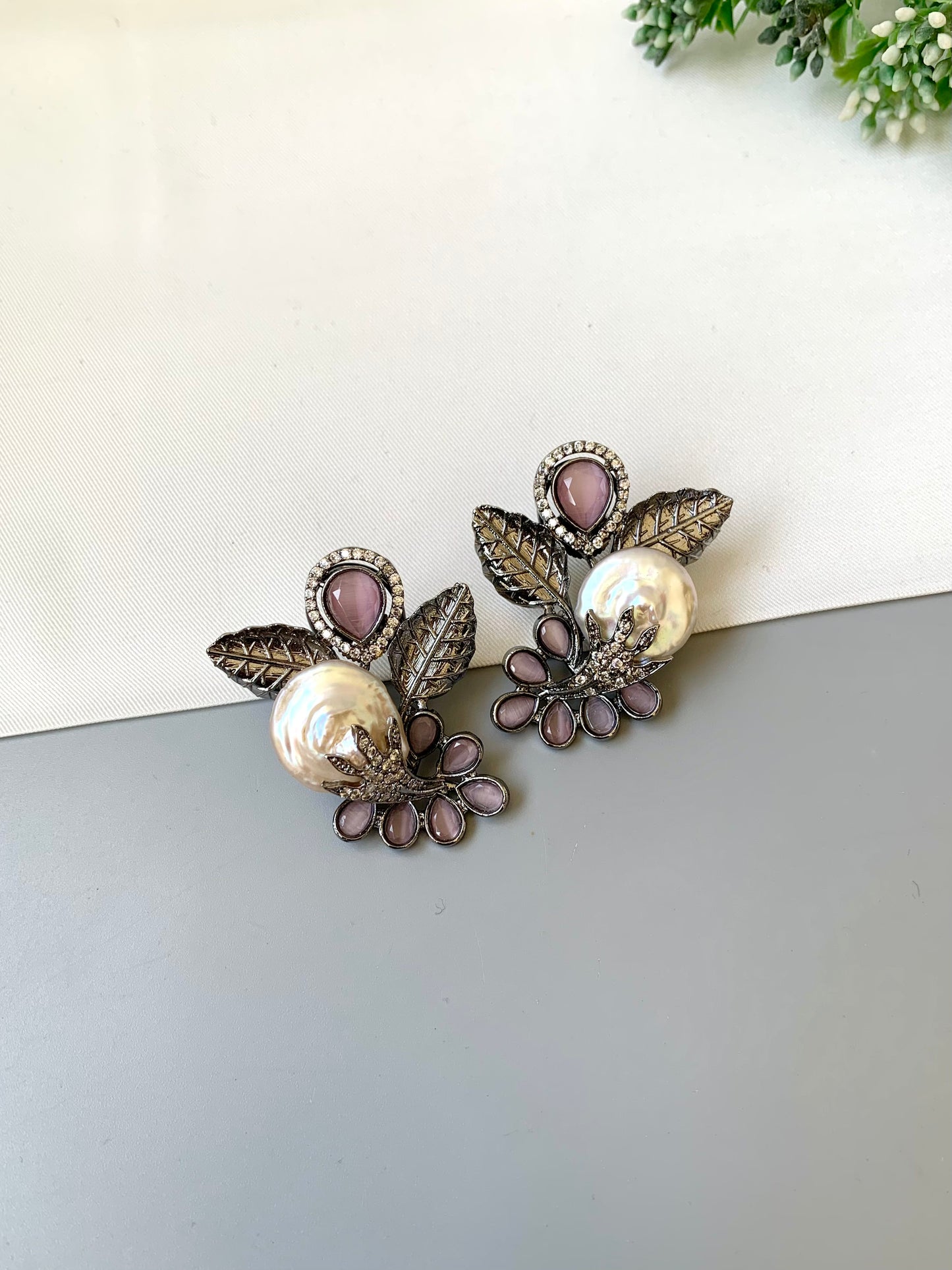 Dennis pink baroque pearl studs in rhodium oxidized finish with onyx and american diamonds