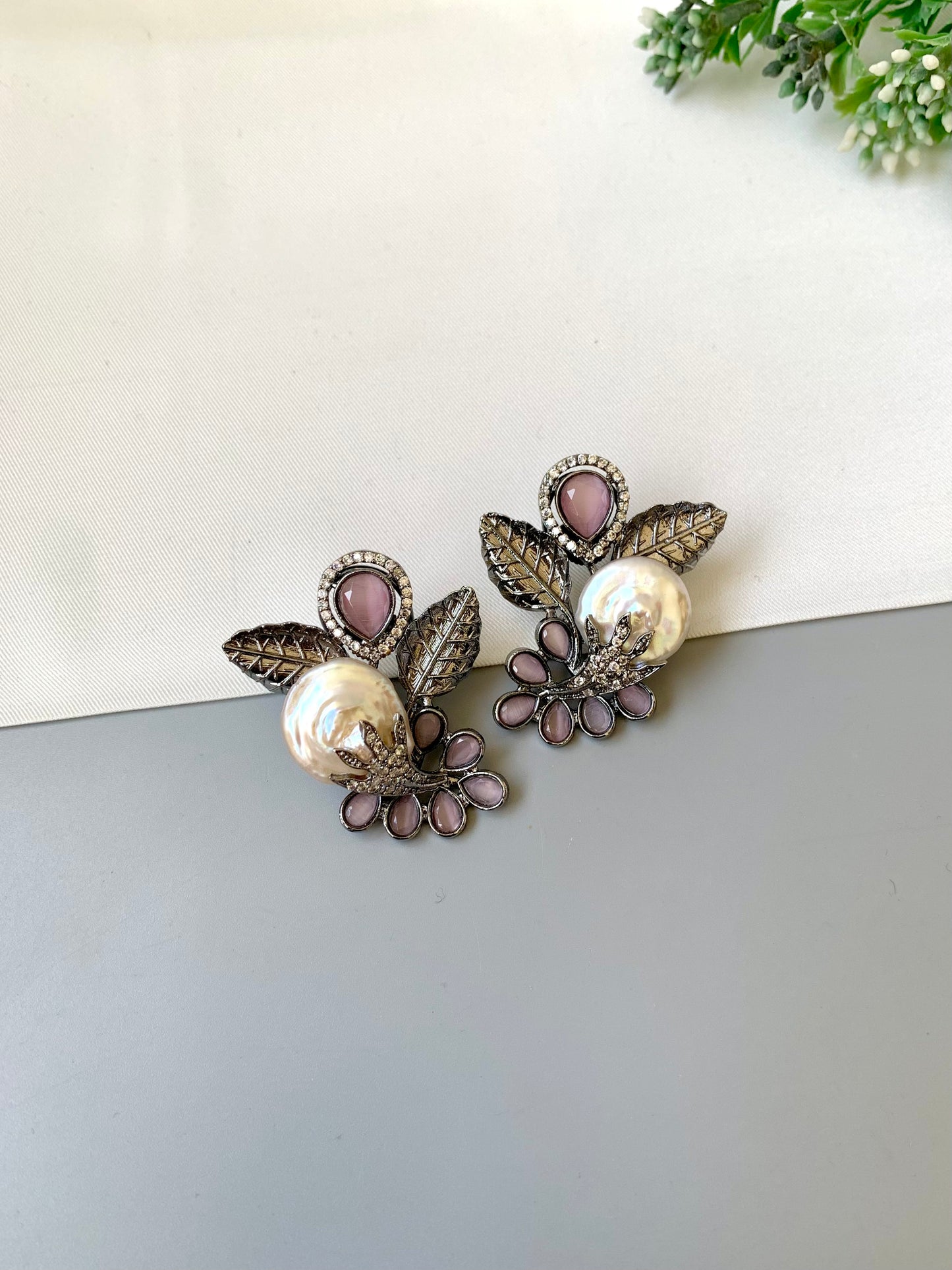 Dennis pink baroque pearl studs in rhodium oxidized finish with onyx and american diamonds