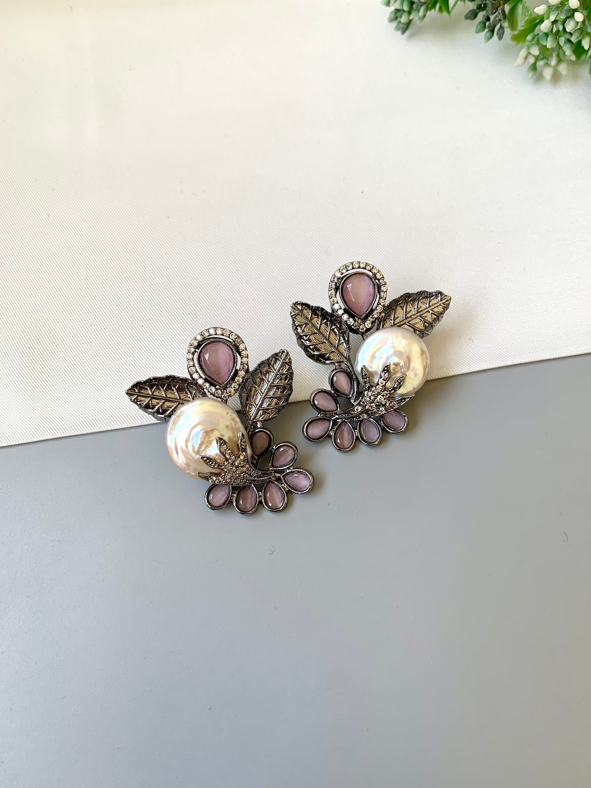 Dennis pink baroque pearl studs in rhodium oxidized finish with onyx and american diamonds