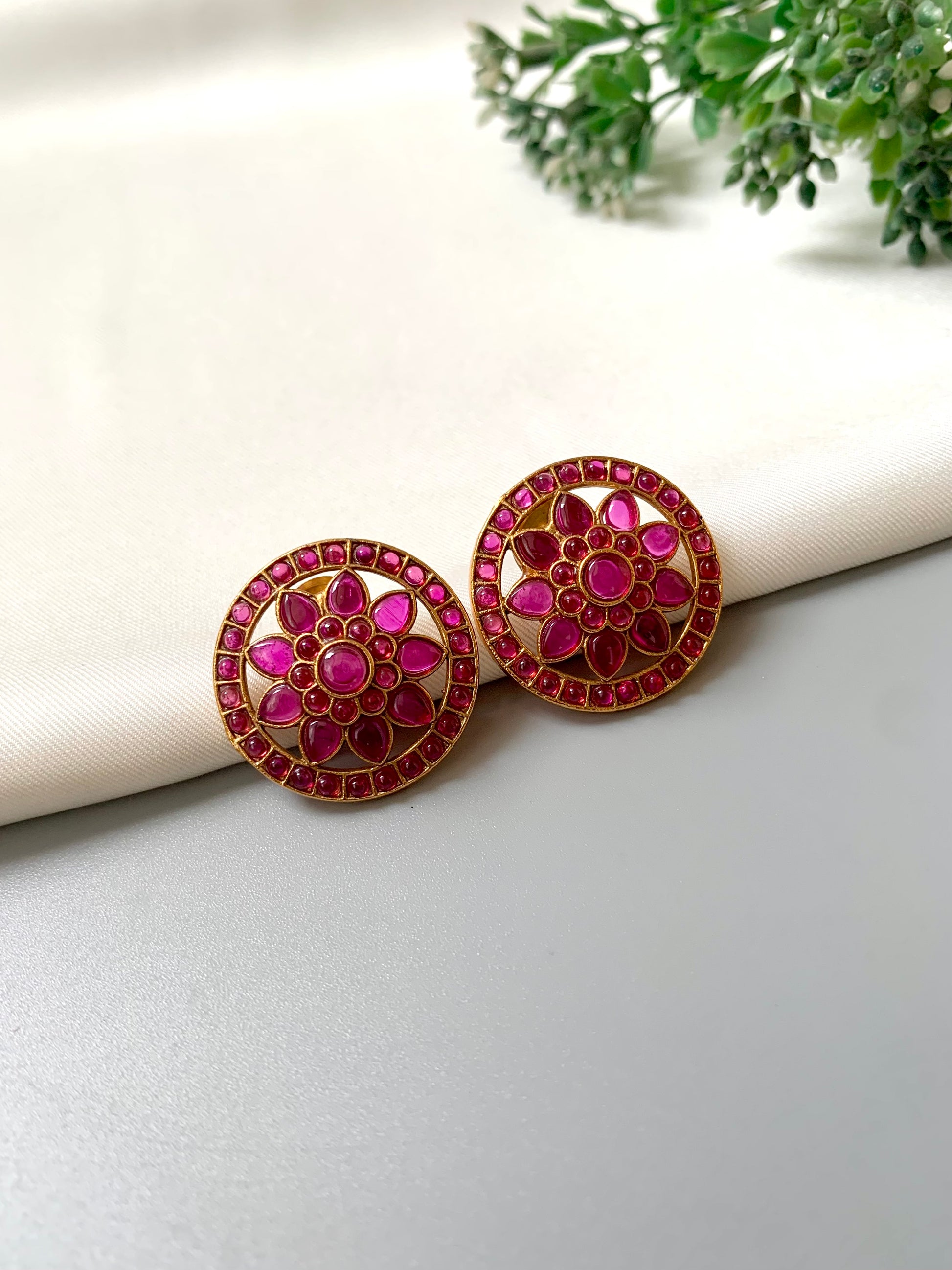 Close side view of Dikhsha Ruby Studs in floral design with Kemp stones