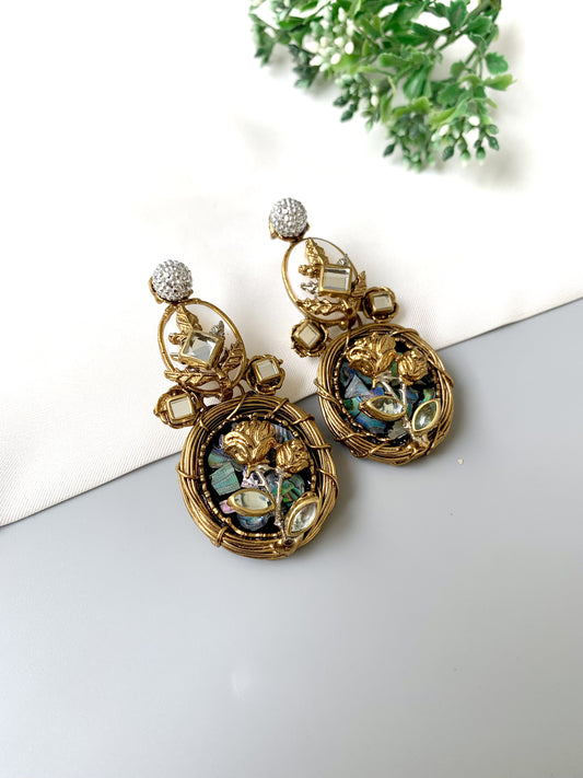Front view of Elara Bloom gold statement earrings with floral design, moonstone and Kundan detailing.