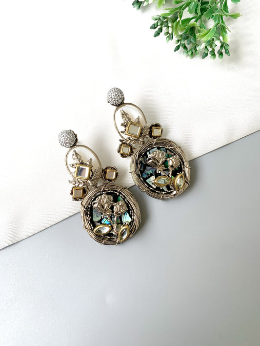 Front view of Elara Bloom silver earrings with floral detailing, American Diamonds, and moonstones in Rhodium finish.
