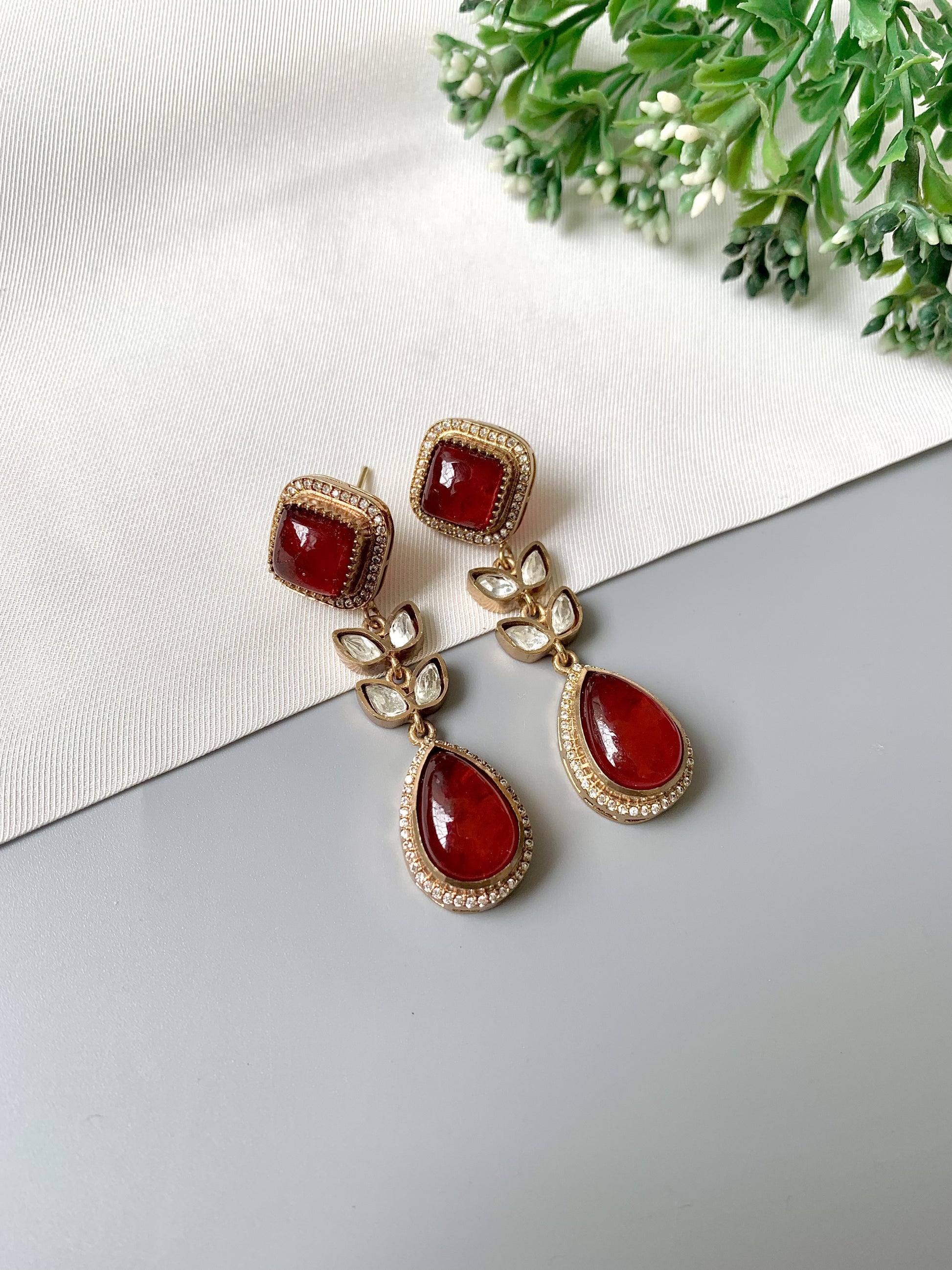 Elayra handcrafted red earrings with teardrop ruby, Polki Kundan, and American Diamonds in a floral gold design