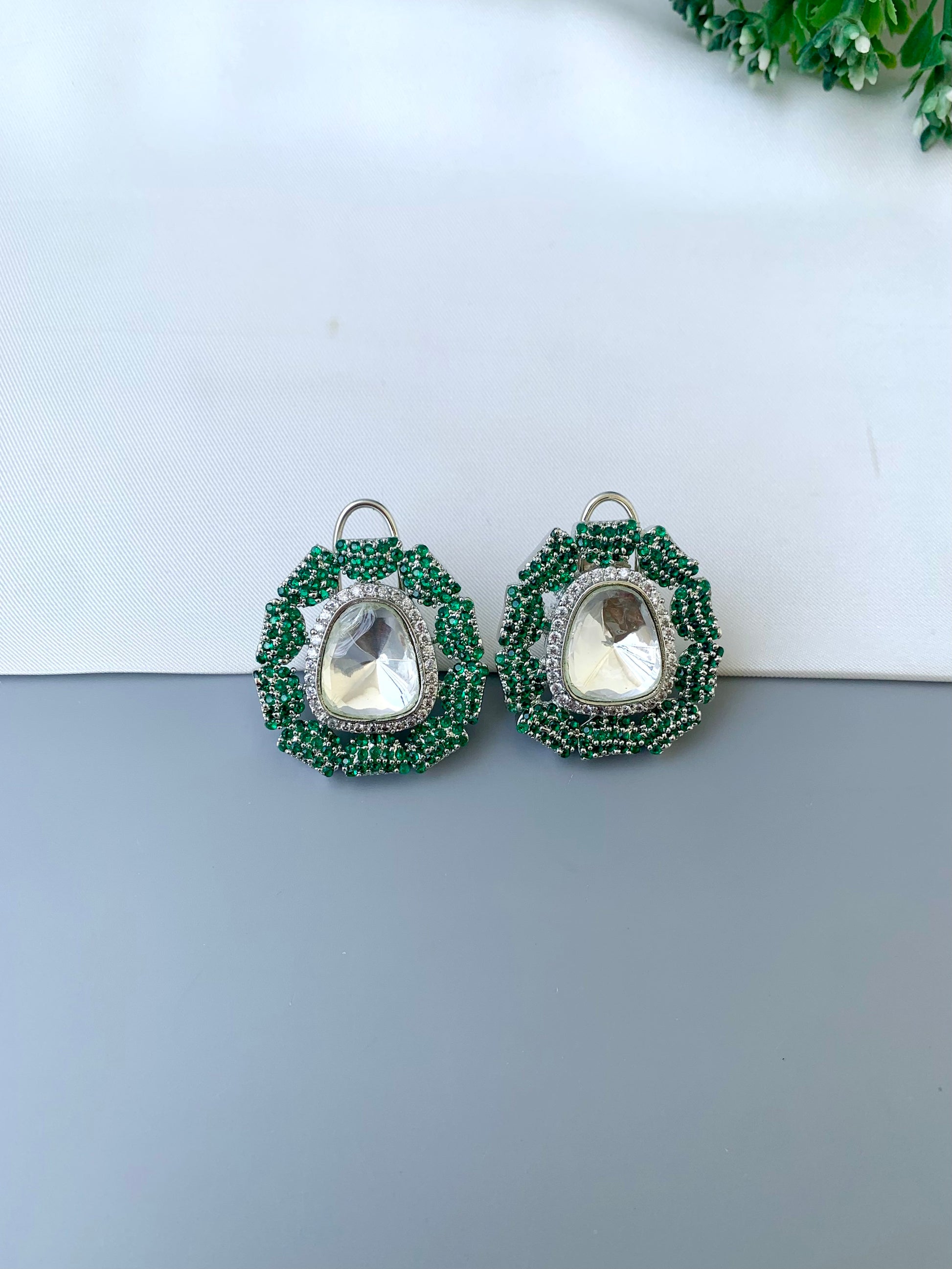 Eliana emerald Swarovski studs in rhodium platinum finish with polki kundan and American diamonds