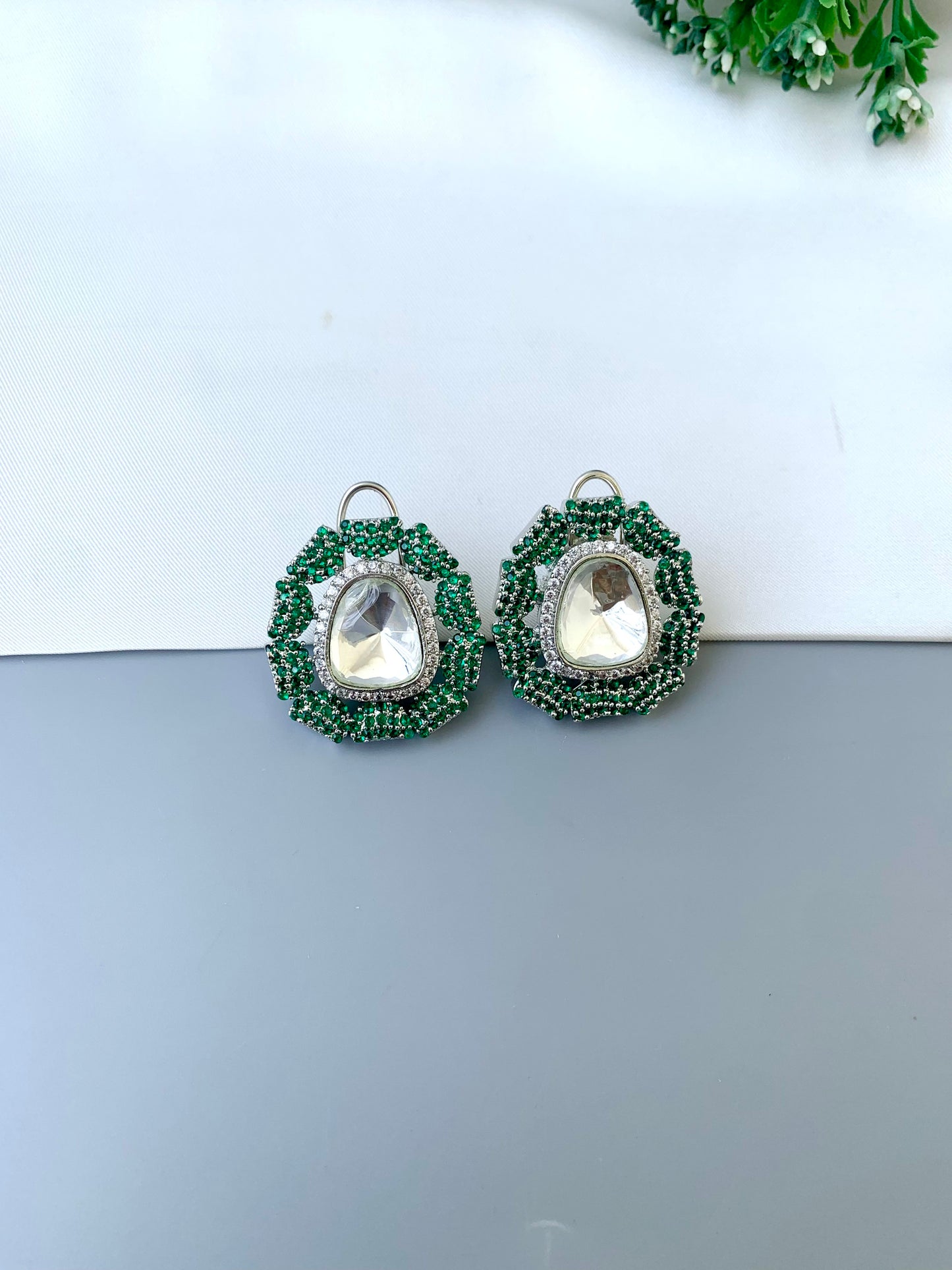 Eliana emerald Swarovski studs in rhodium platinum finish with polki kundan and American diamonds