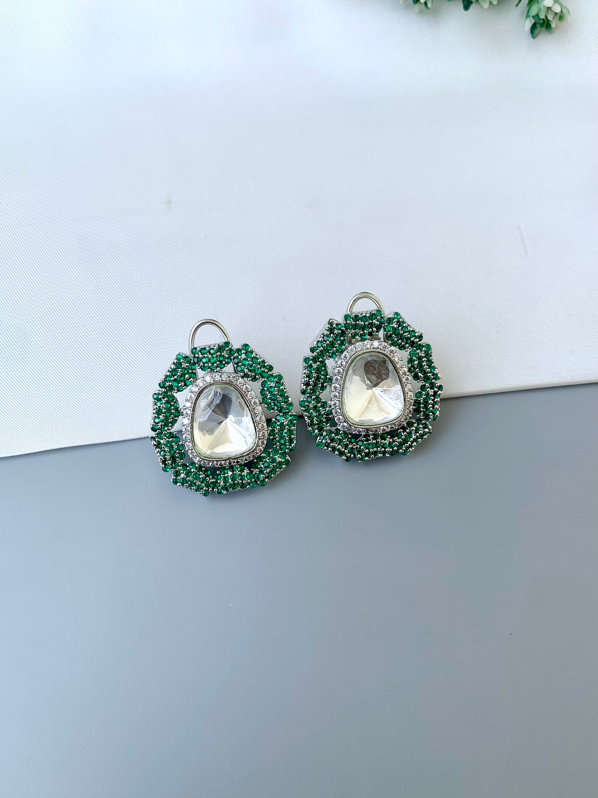Eliana emerald Swarovski studs in rhodium platinum finish with polki kundan and American diamonds