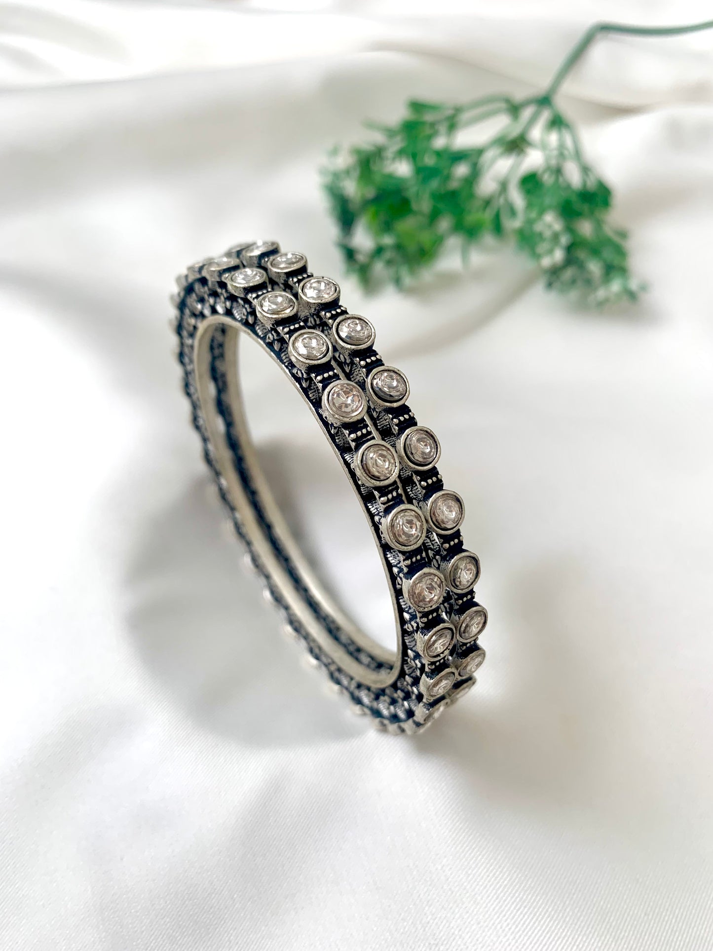 Eve handcrafted rhodium plated bangles with oxidized black polish and high quality Polki Kundan, sold as a pair