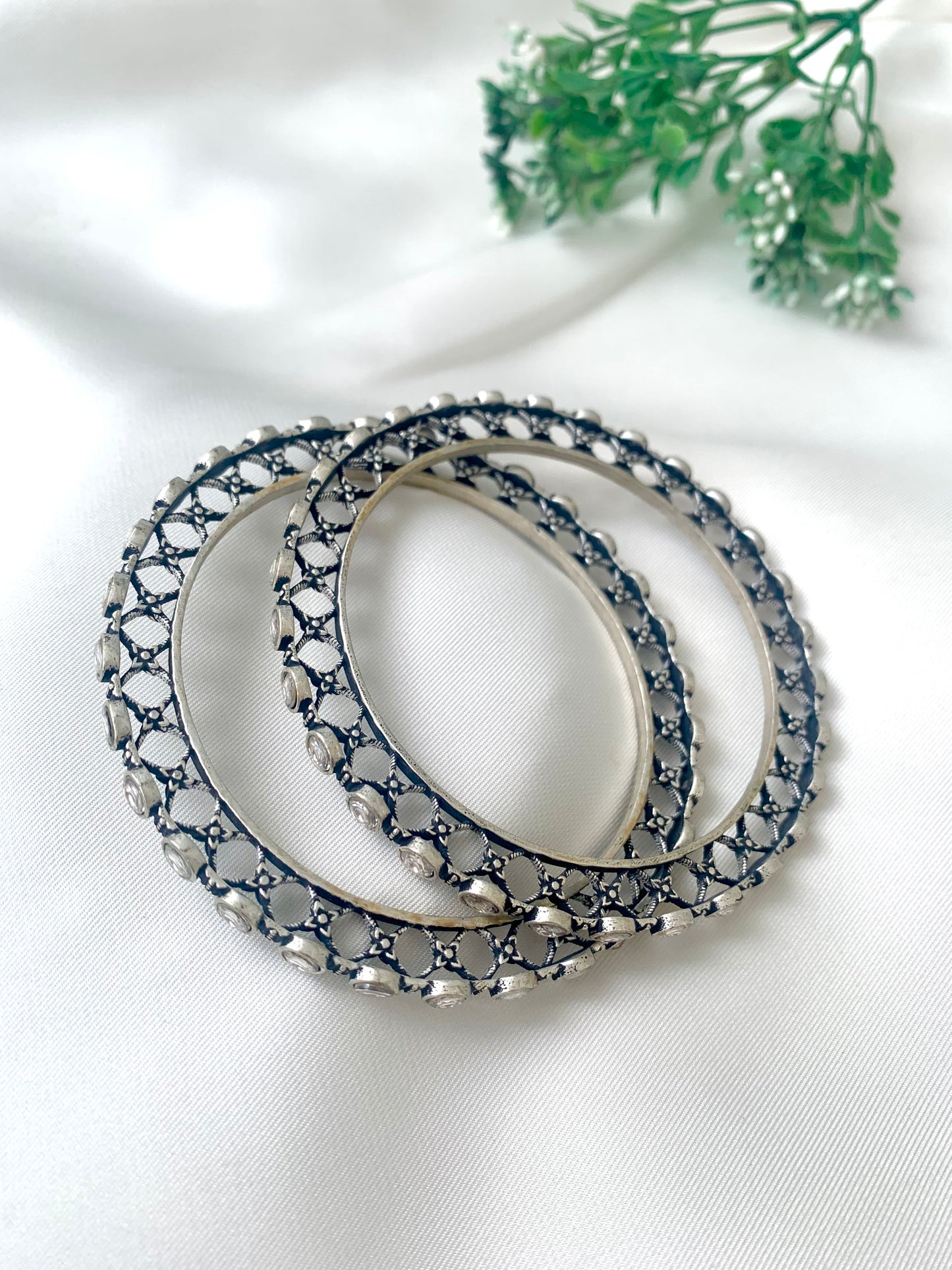 Eve handcrafted rhodium plated bangles with oxidized black polish and high quality Polki Kundan, sold as a pair