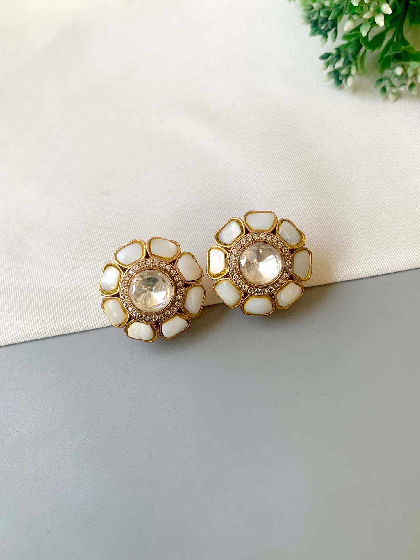 Hand crafted Fleur flower-shaped studs in 22kt gold plating with American Diamonds, Polki Kundan and real Mother of Pearl
