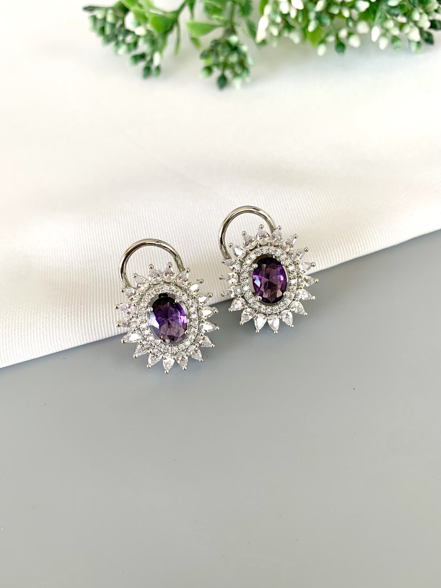 Angled close-up showing deep purple Amethyst stone and icy diamond halo setting
