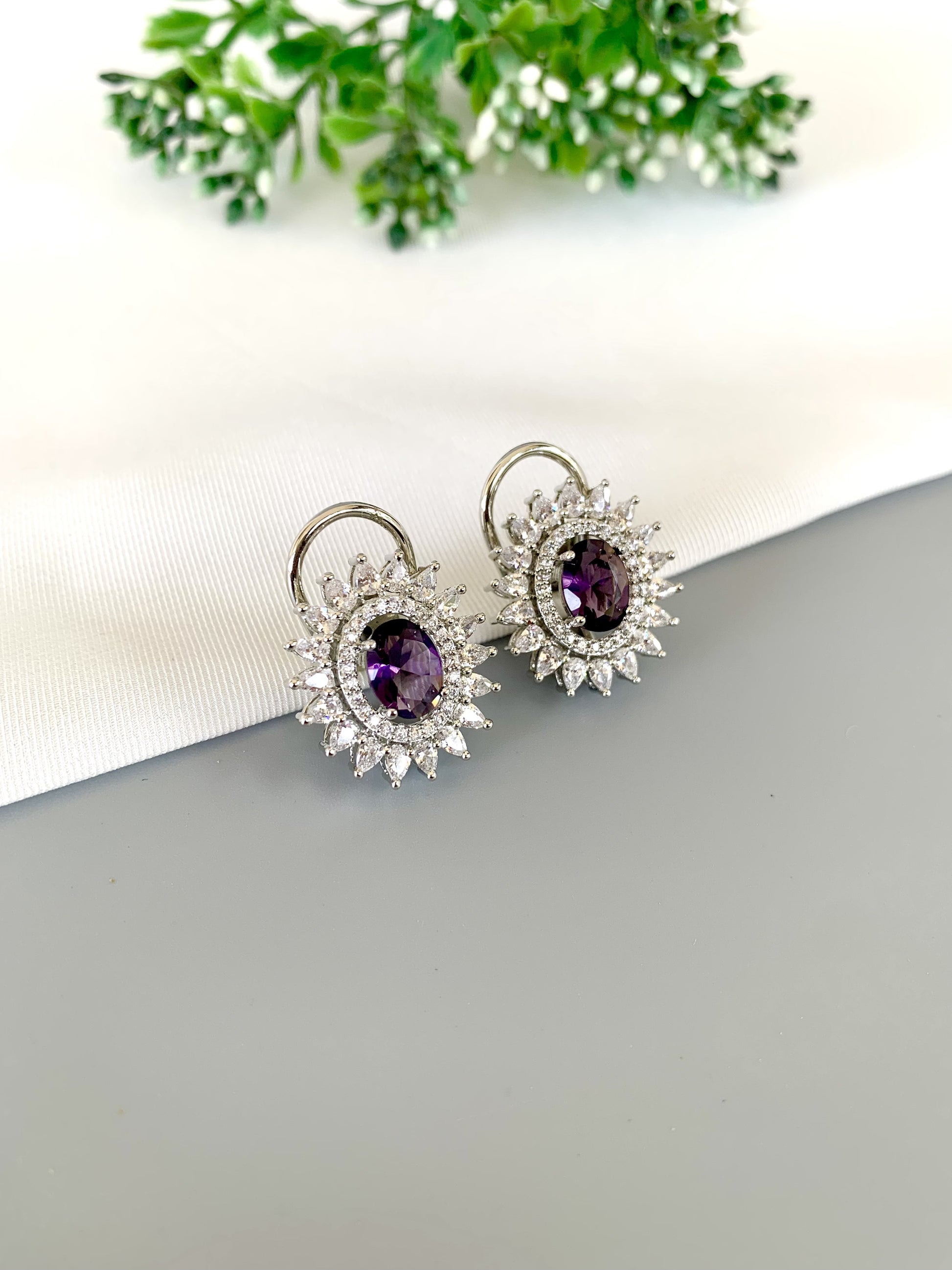 Front view of Hermona Amethyst Studs in rhodium finish with American Diamond surround