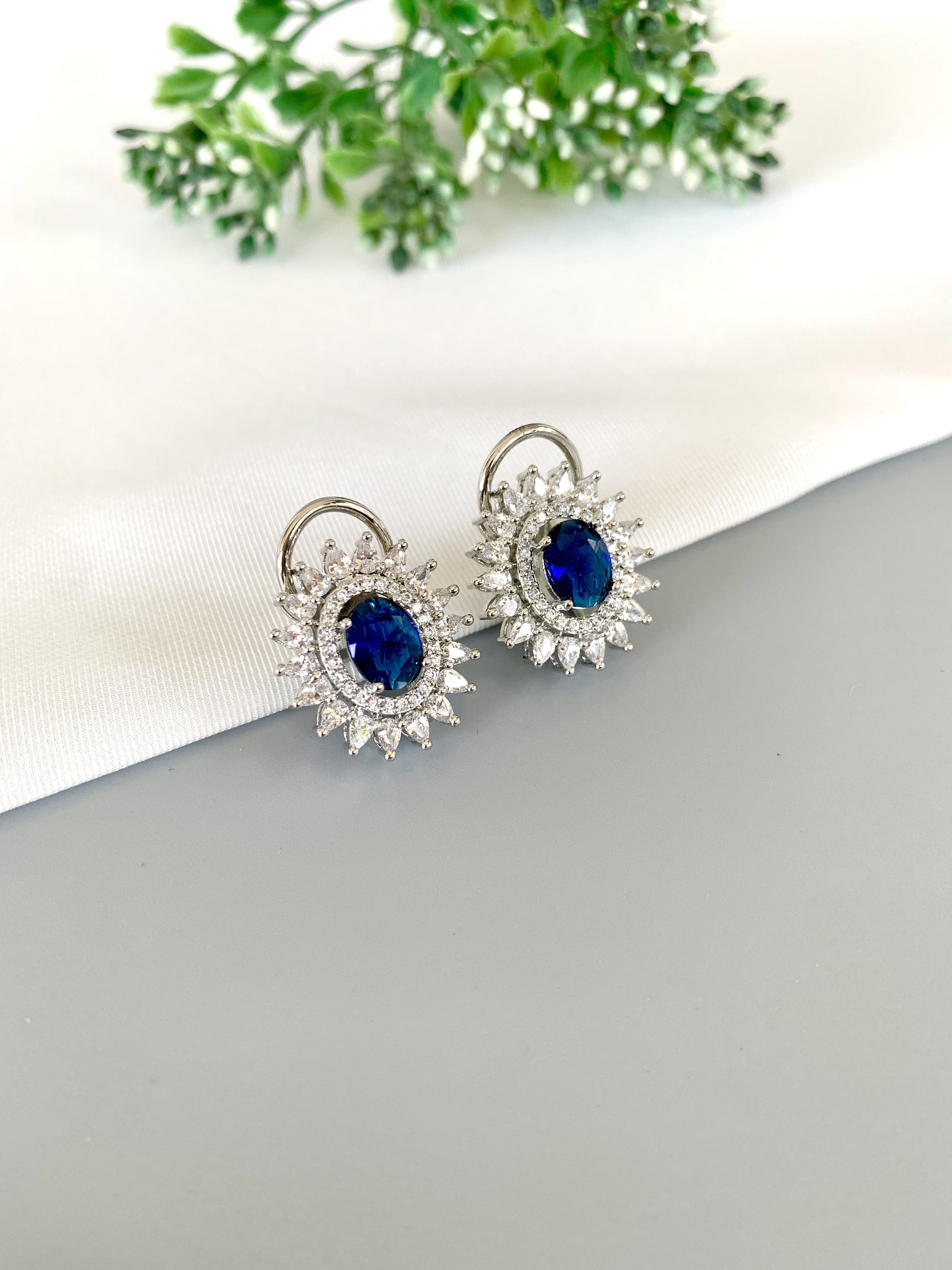 Close-up of deep blue Sapphire center with radiant surround on platinum-toned base