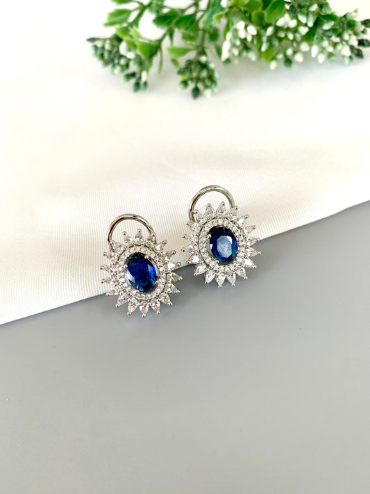 Front view of Hermona Sapphire Studs in Rhodium finish with American Diamond halo