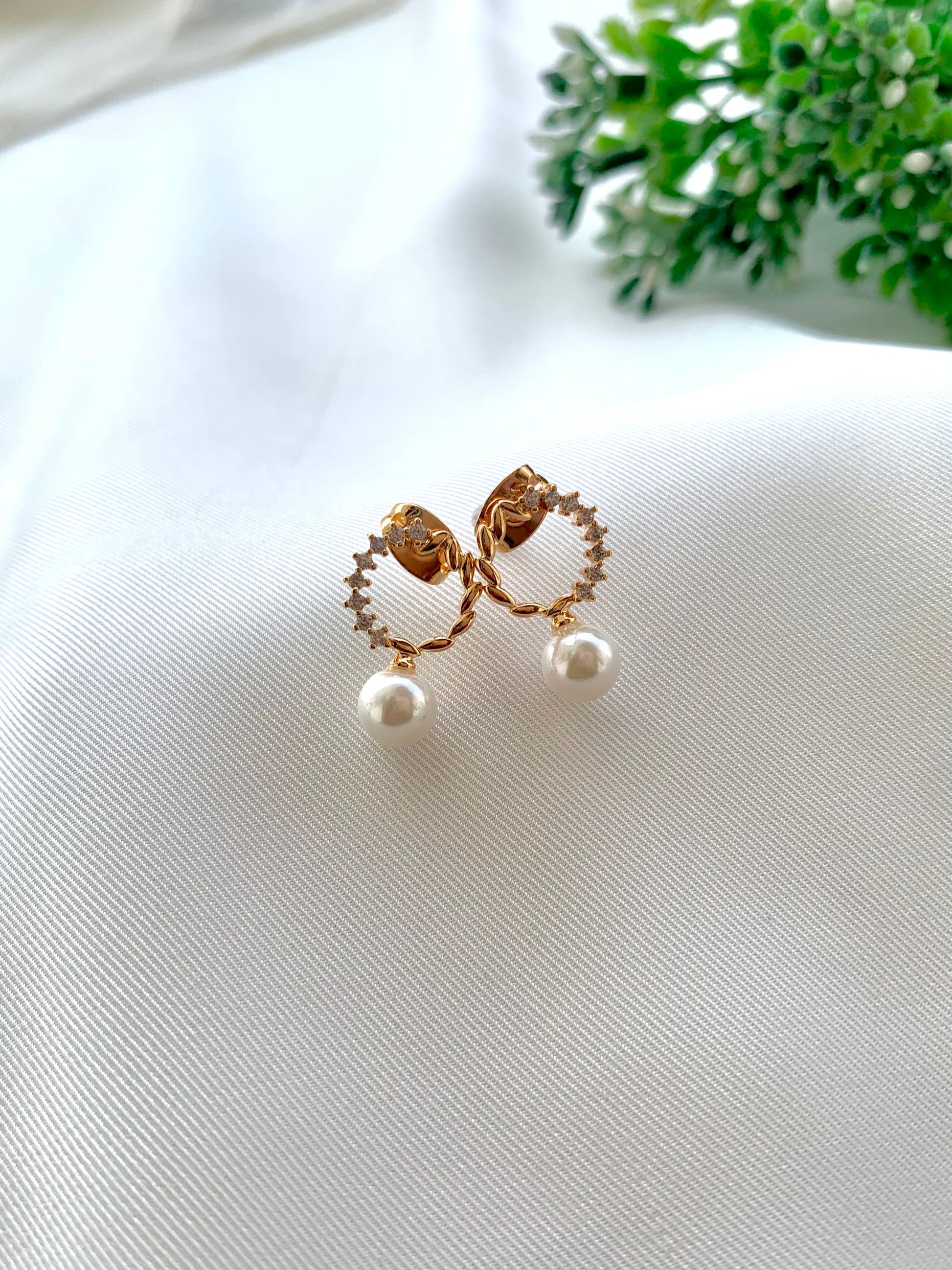 Ikna gold plated studs with American diamonds and pearl accents
