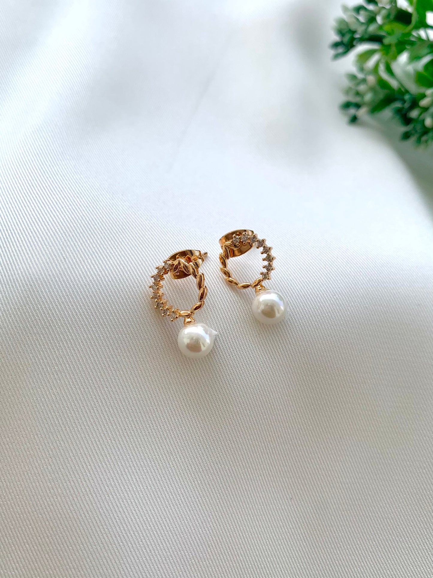 Ikna gold plated studs with American diamonds and pearl accents