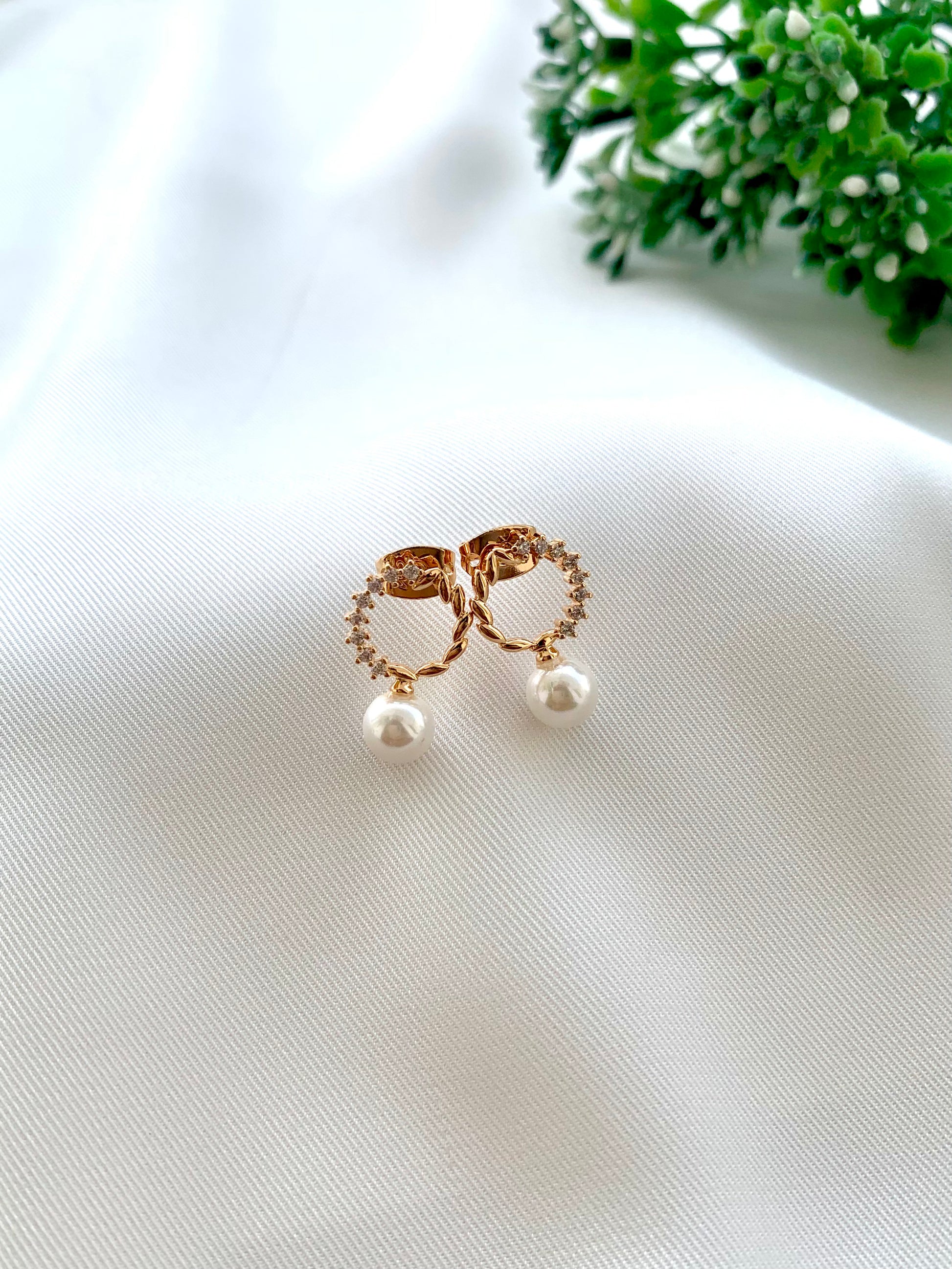 Ikna gold plated studs with American diamonds and pearl accents