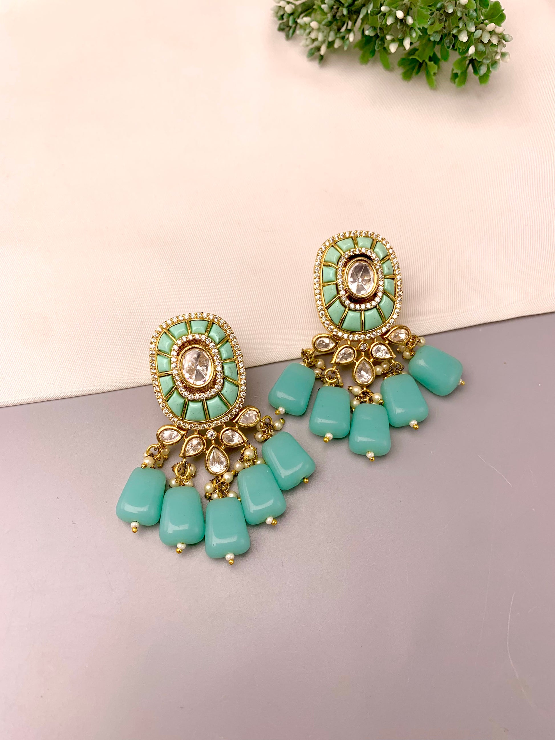 Irmah handcrafted 22kt gold plated earrings featuring American Diamonds, Polki Kundan, semi-precious Pearls, and Feroza