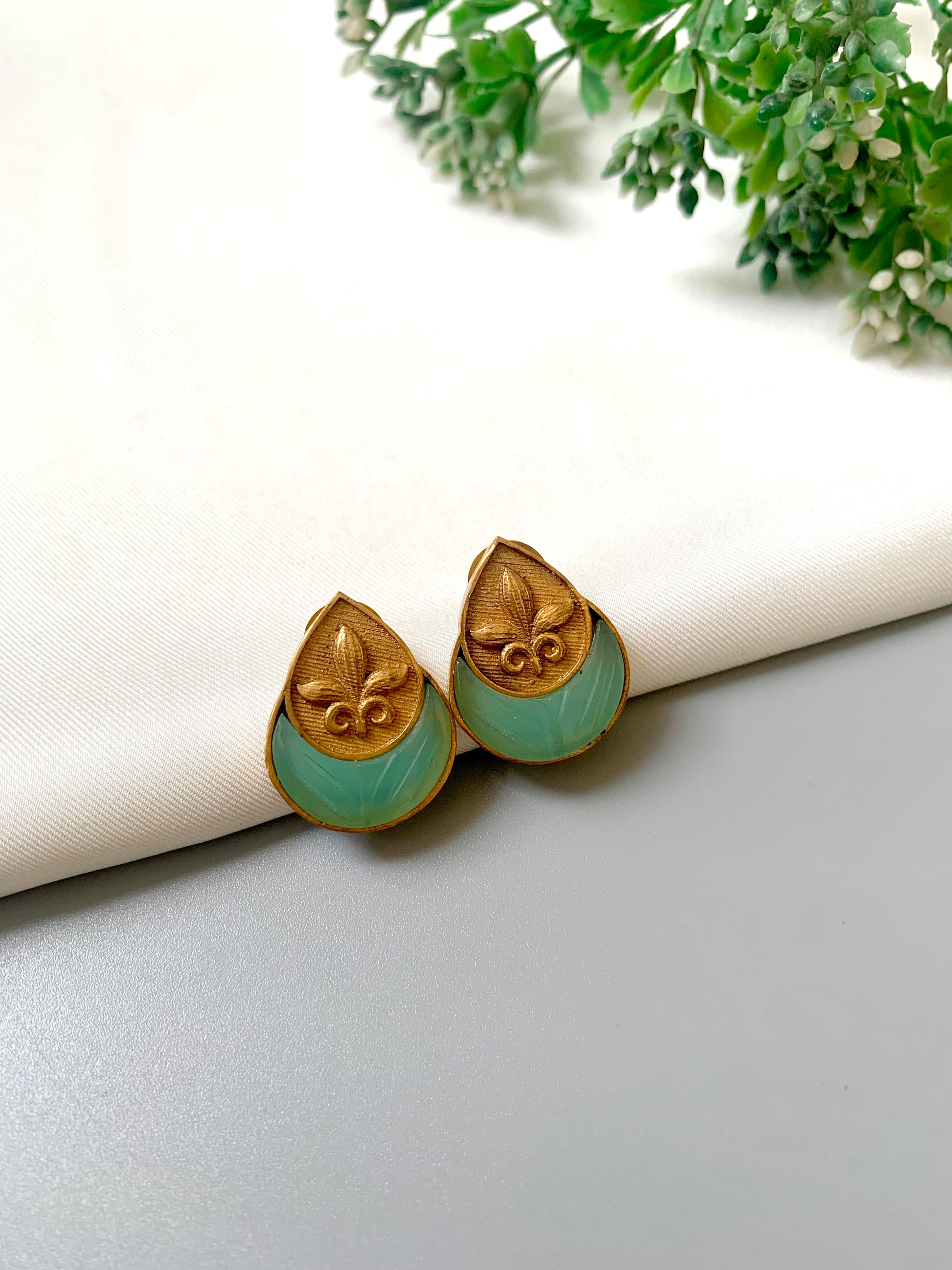 Side angle of Mint Ishani Studs showcasing intricate hand carving