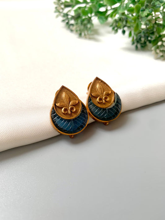 Handcrafted 22kt Victorian Gold plated Ishani studs featuring semi-precious hand-carved Sapphire stones in a matte finish.