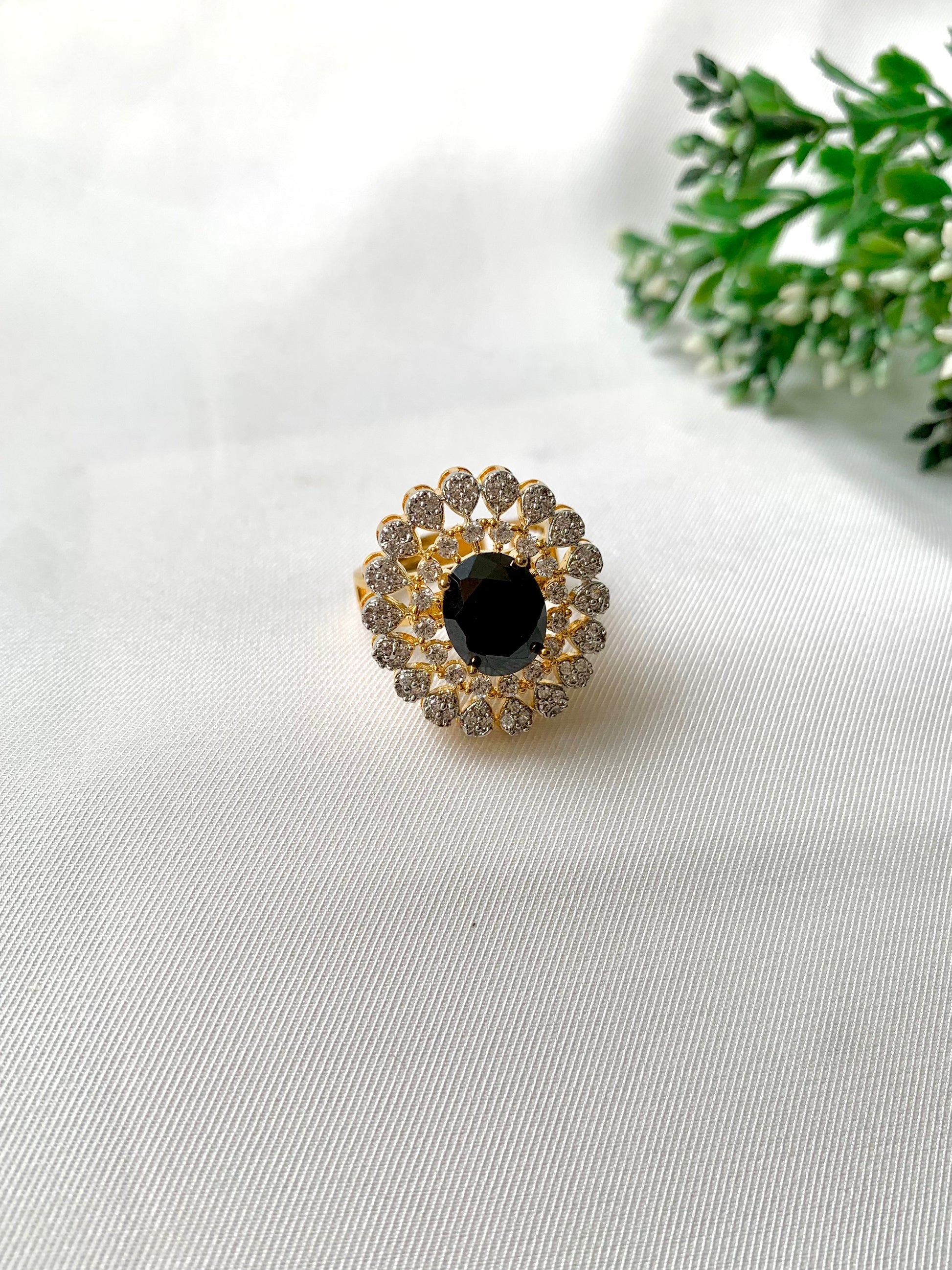 Adjustable Onyx and Diamond cocktail ring on white fabric
