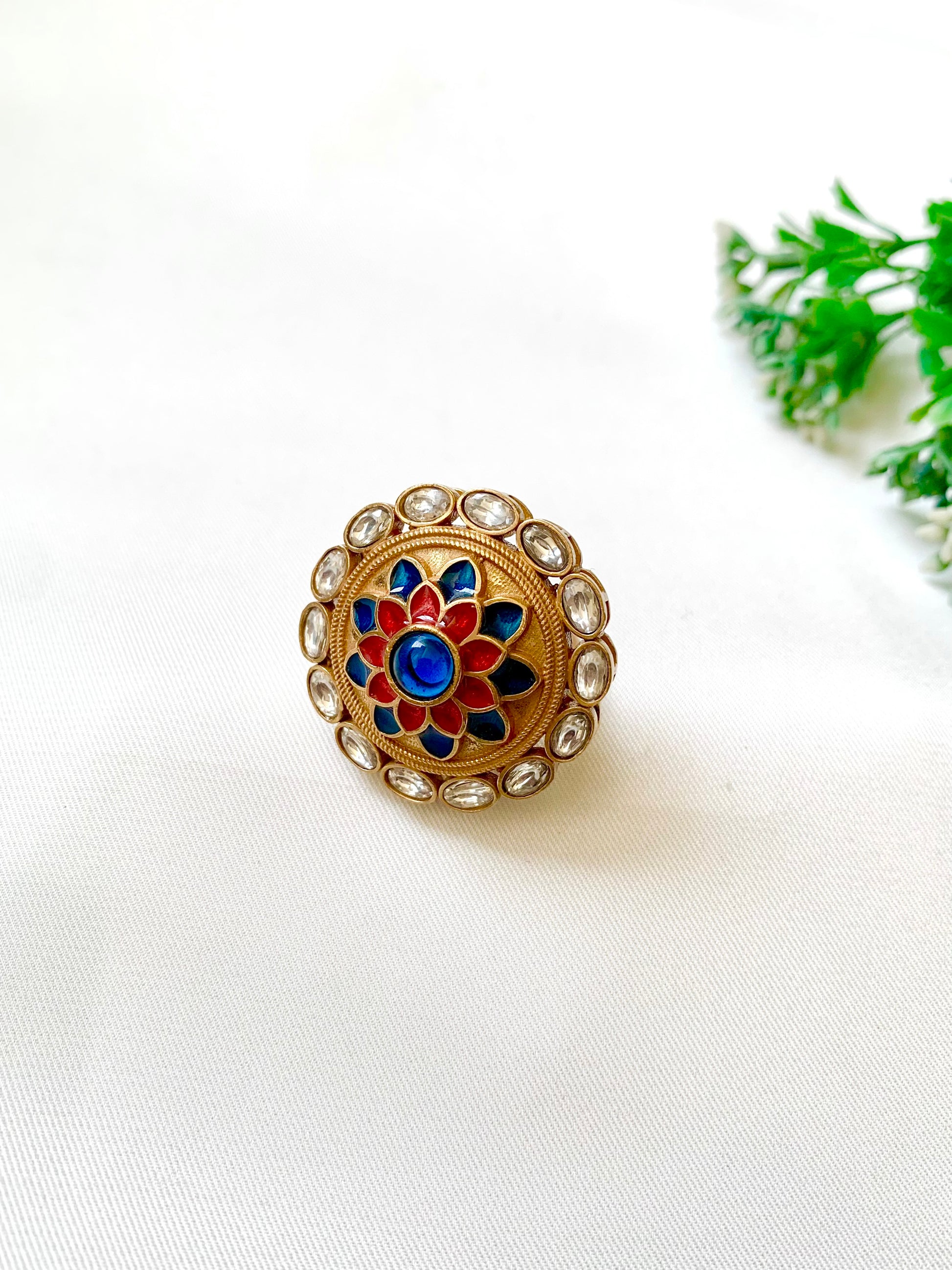 Decorative ring with colorful gemstones on a white background