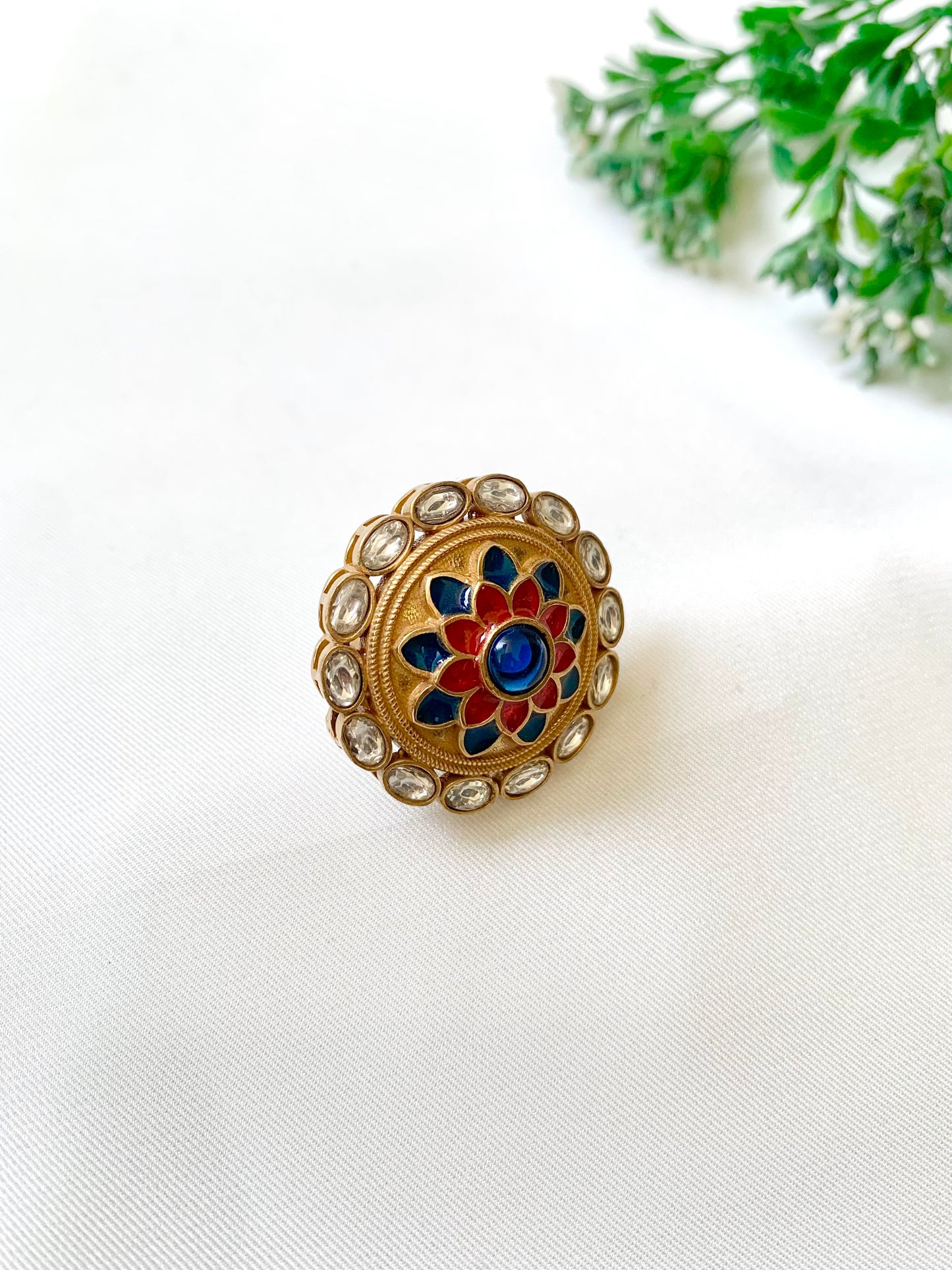 Decorative ring with floral design on a white surface