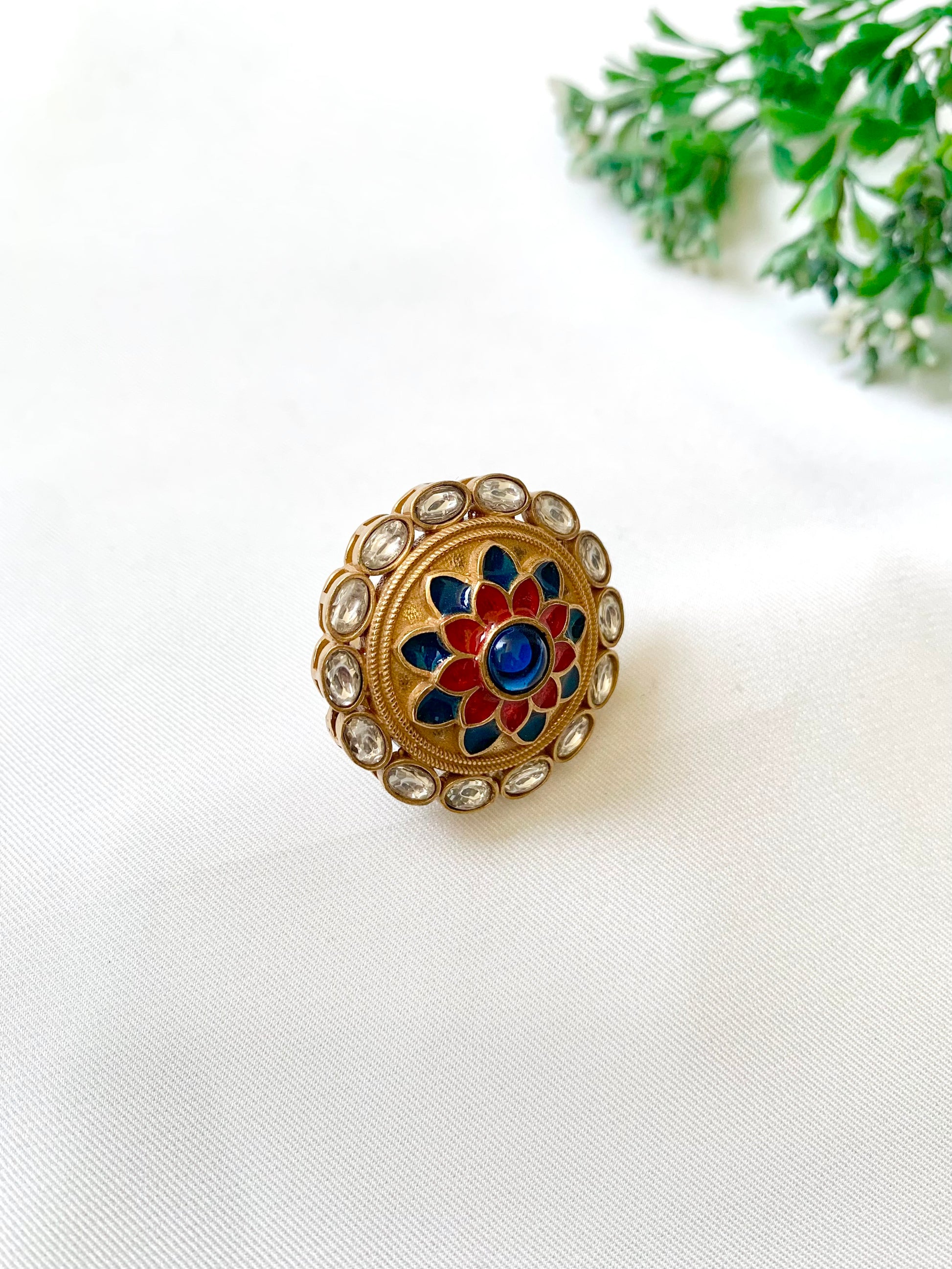 Decorative ring with floral design on a white surface