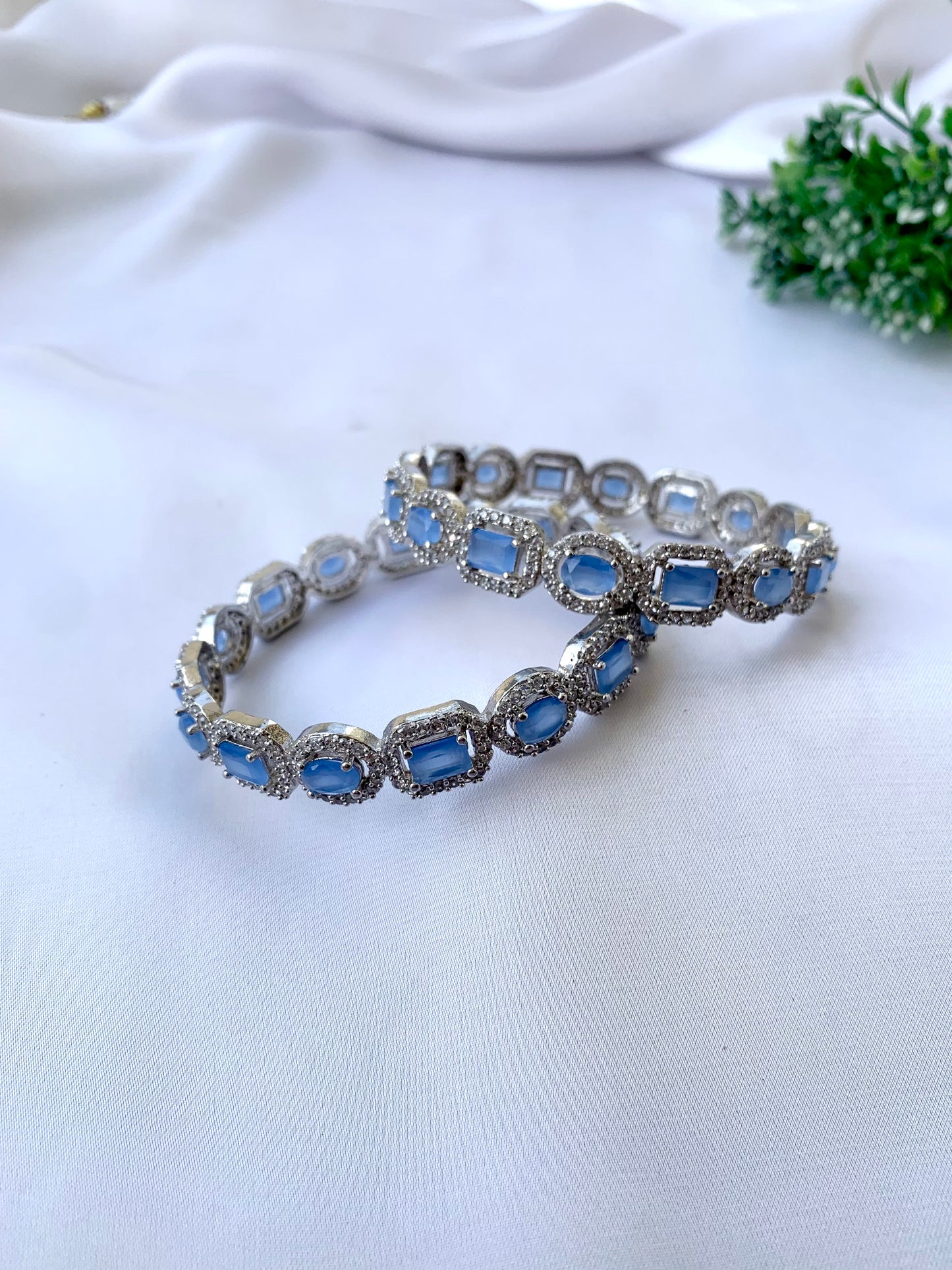 Julias onyx rhodium plated bangles in platinum polish with American diamonds