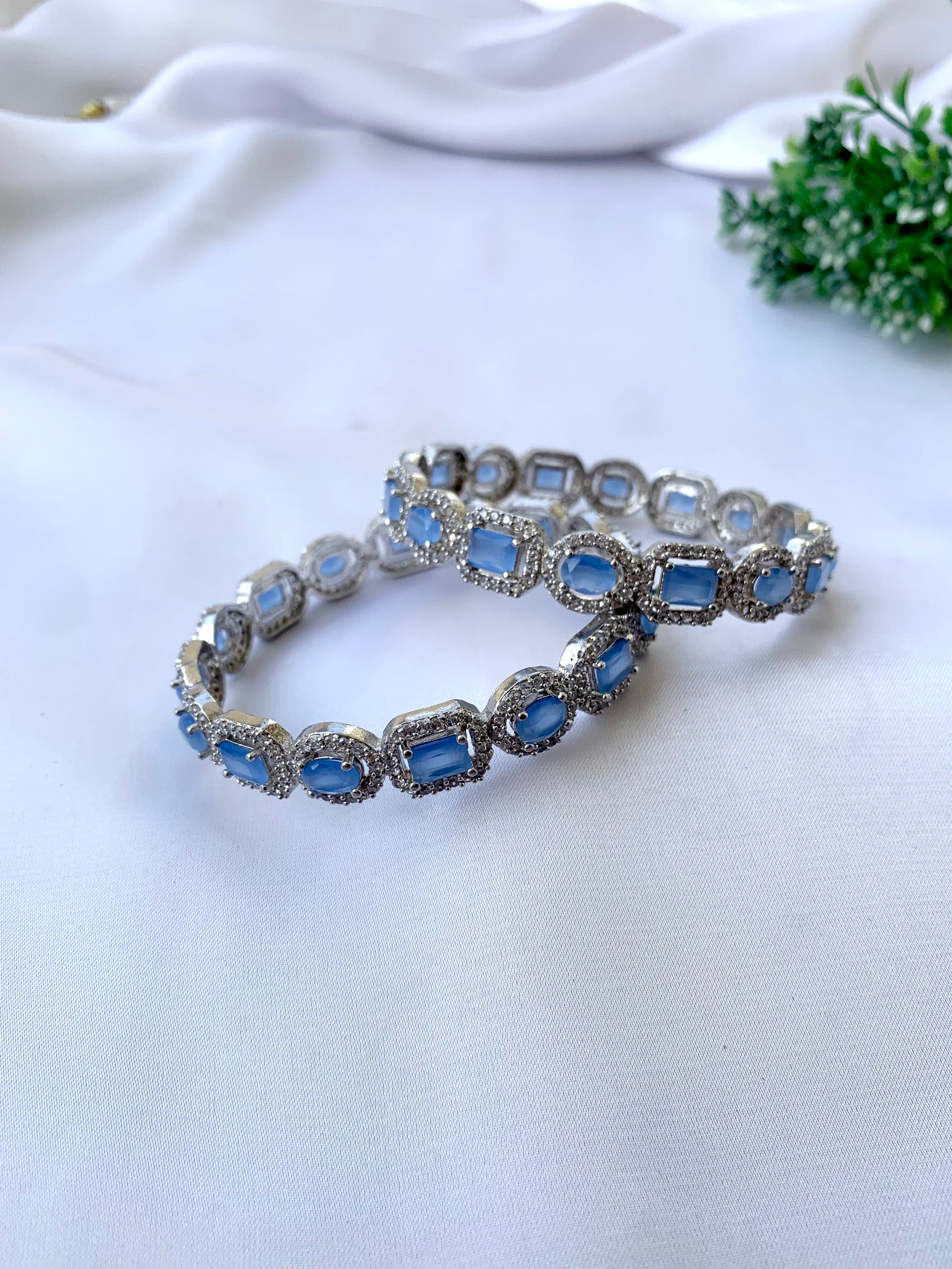 Julias onyx rhodium plated bangles in platinum polish with American diamonds