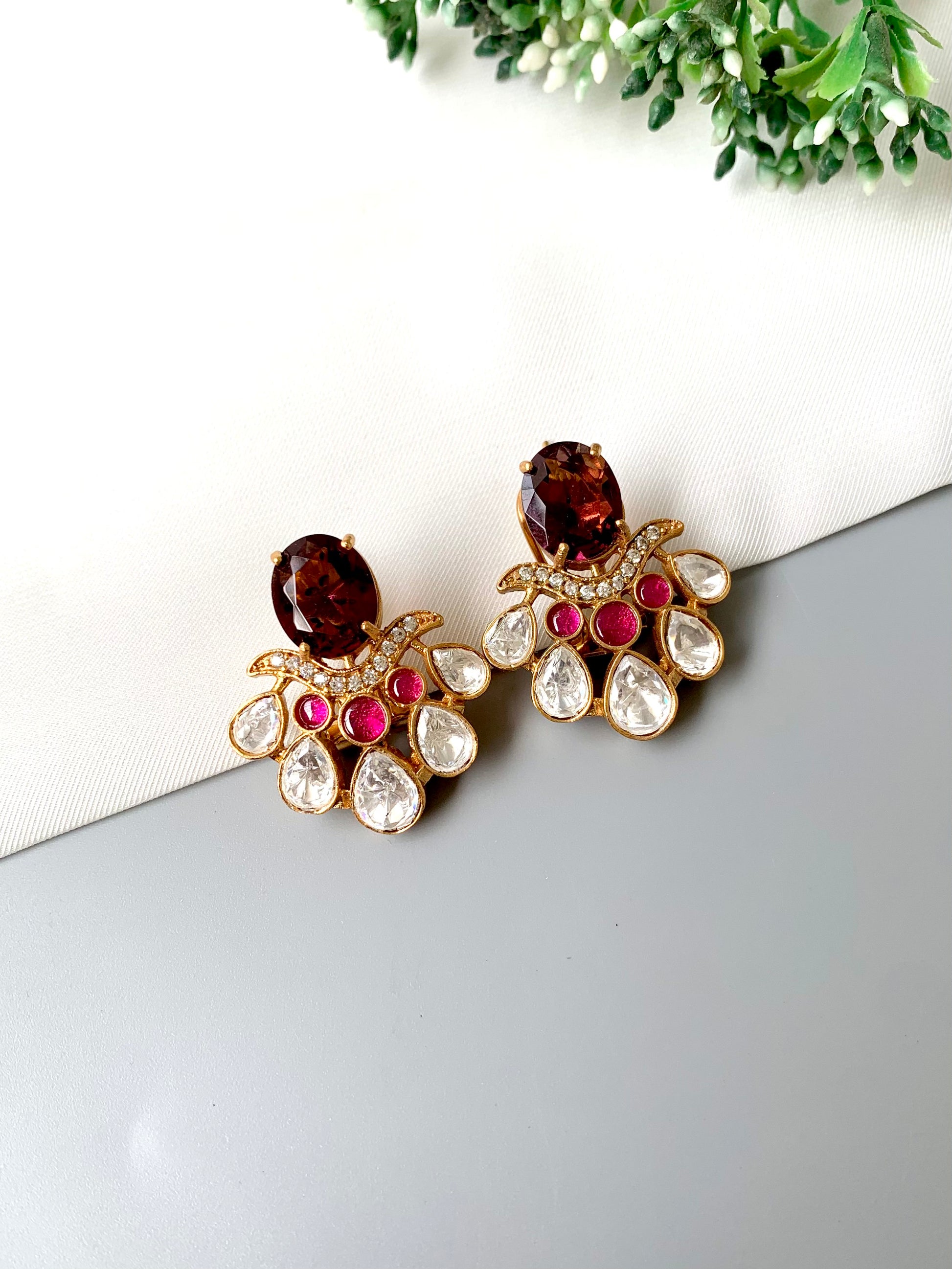 Top-angle view of Kavia Amethyst earrings with rich amethyst centerpiece and oxidized gold polish.