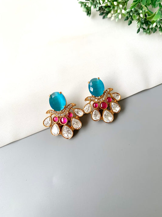Front view of Kavia Feroza earrings with Feroza, ruby and Polki Kundan stones in 22kt gold.