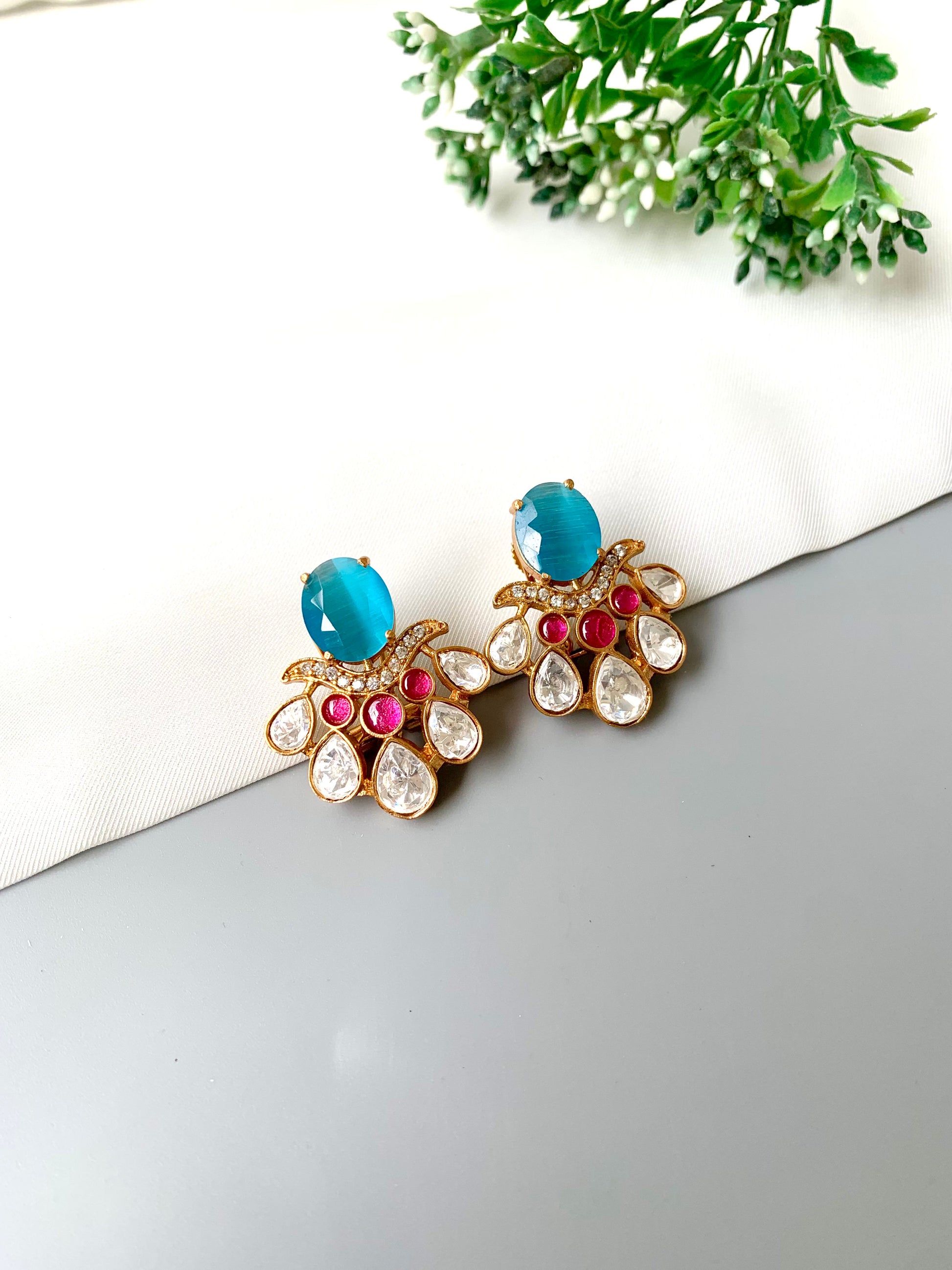 Side view of Kavia Feroza earrings highlighting ruby accents and intricate Kundan setting.