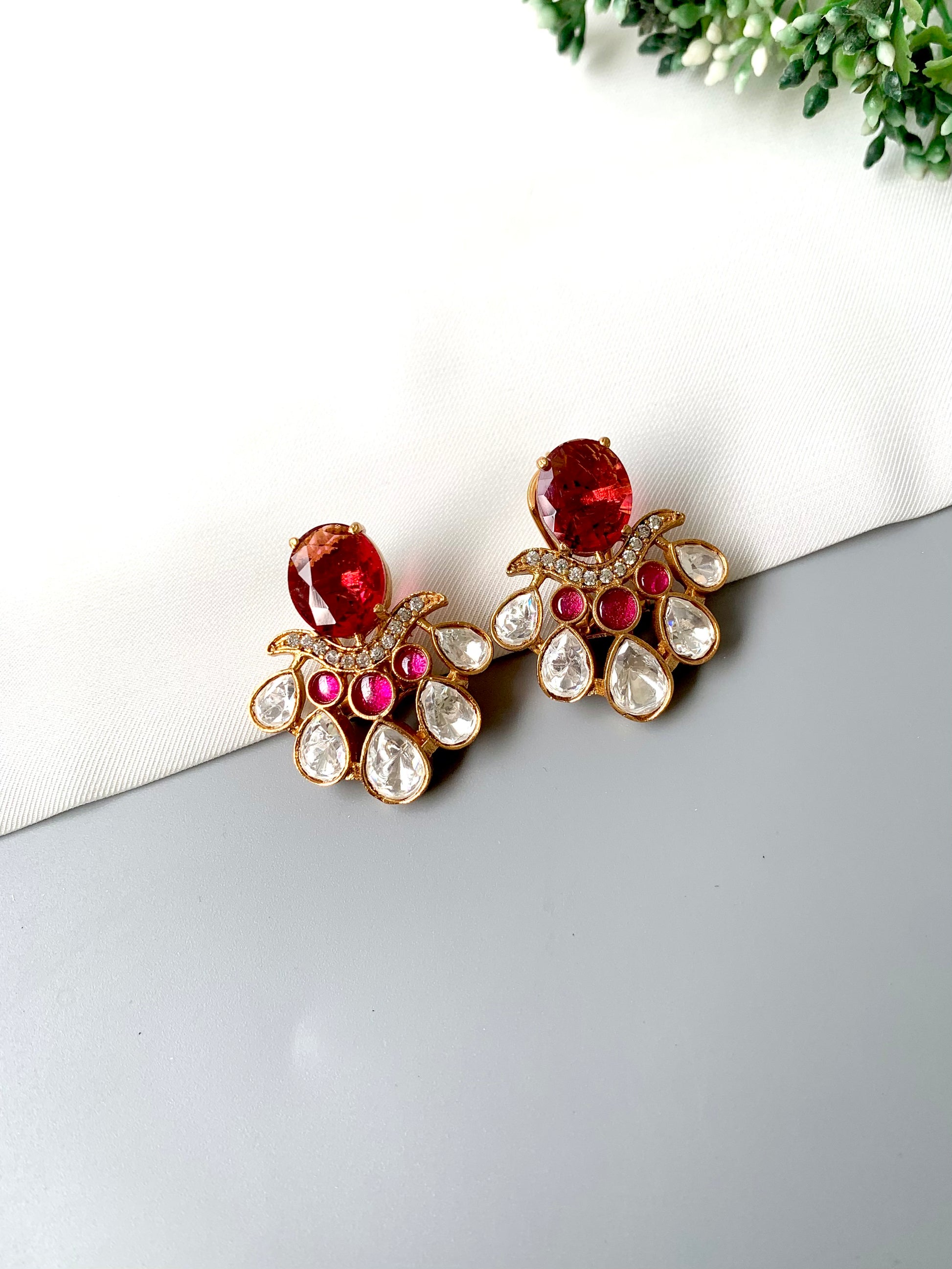 Close-up image of Kavia Ruby earrings showing intricate teardrop diamond details and ruby centerpiece.