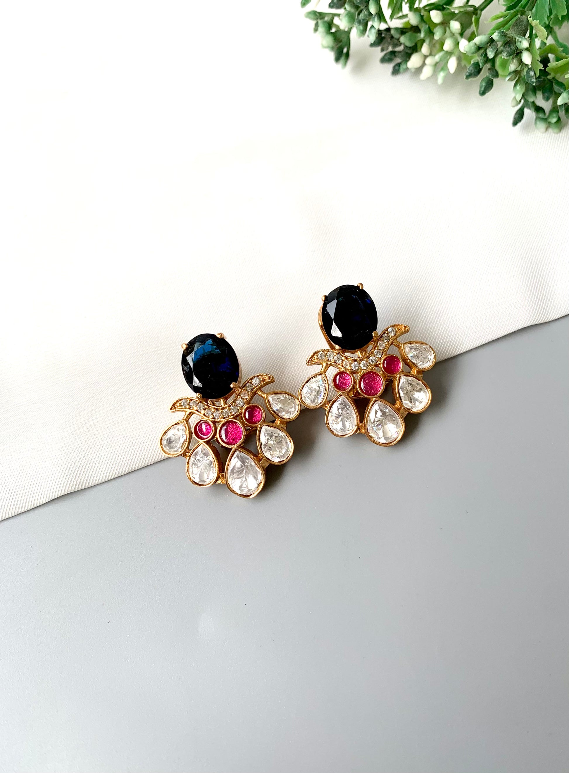 Side view of Kavia Sapphire earrings with handcrafted detailing in gold and stone embellishments.