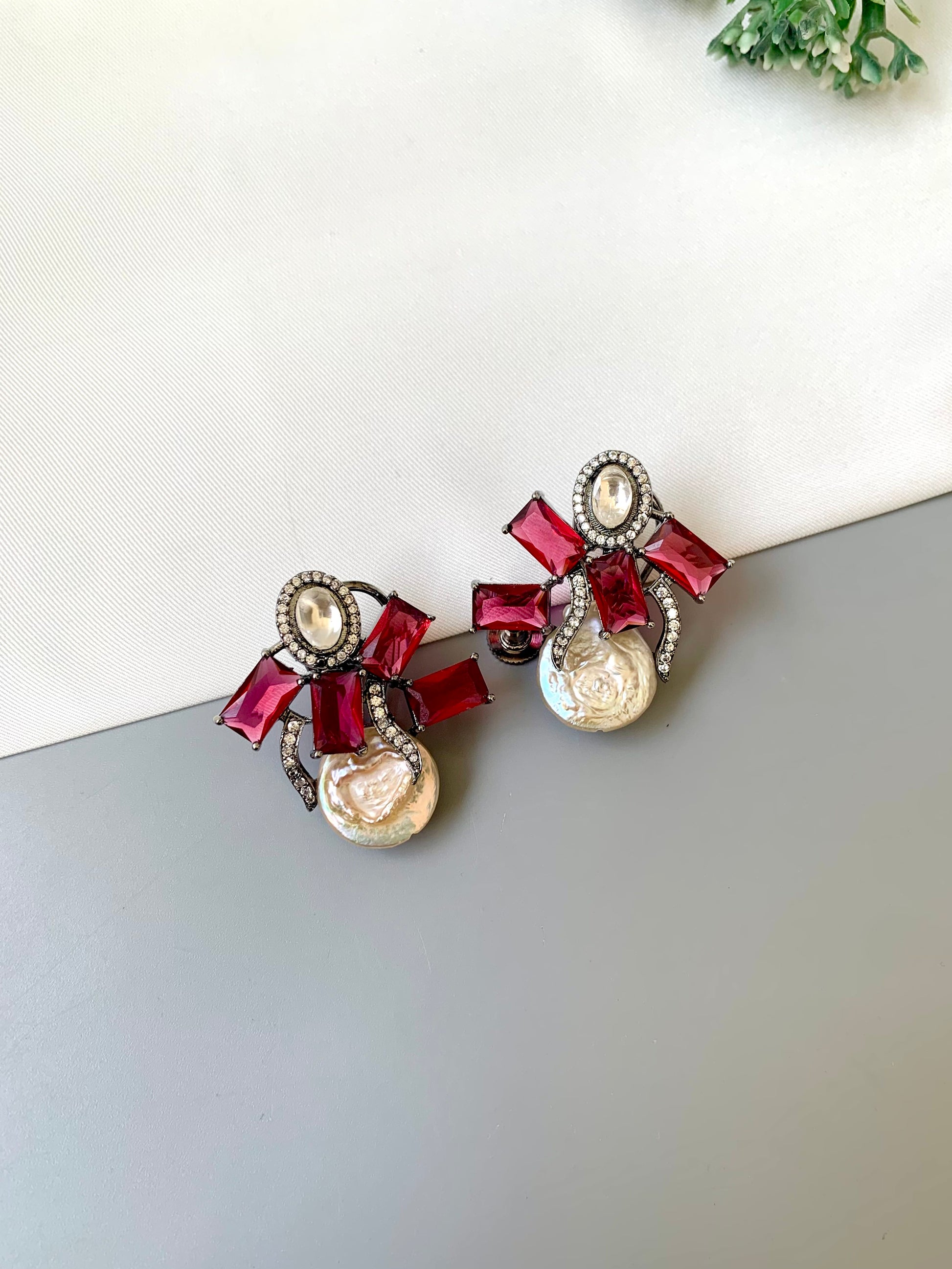 Klara ruby polki kundan studs in rhodium oxidized finish with baroque pearls