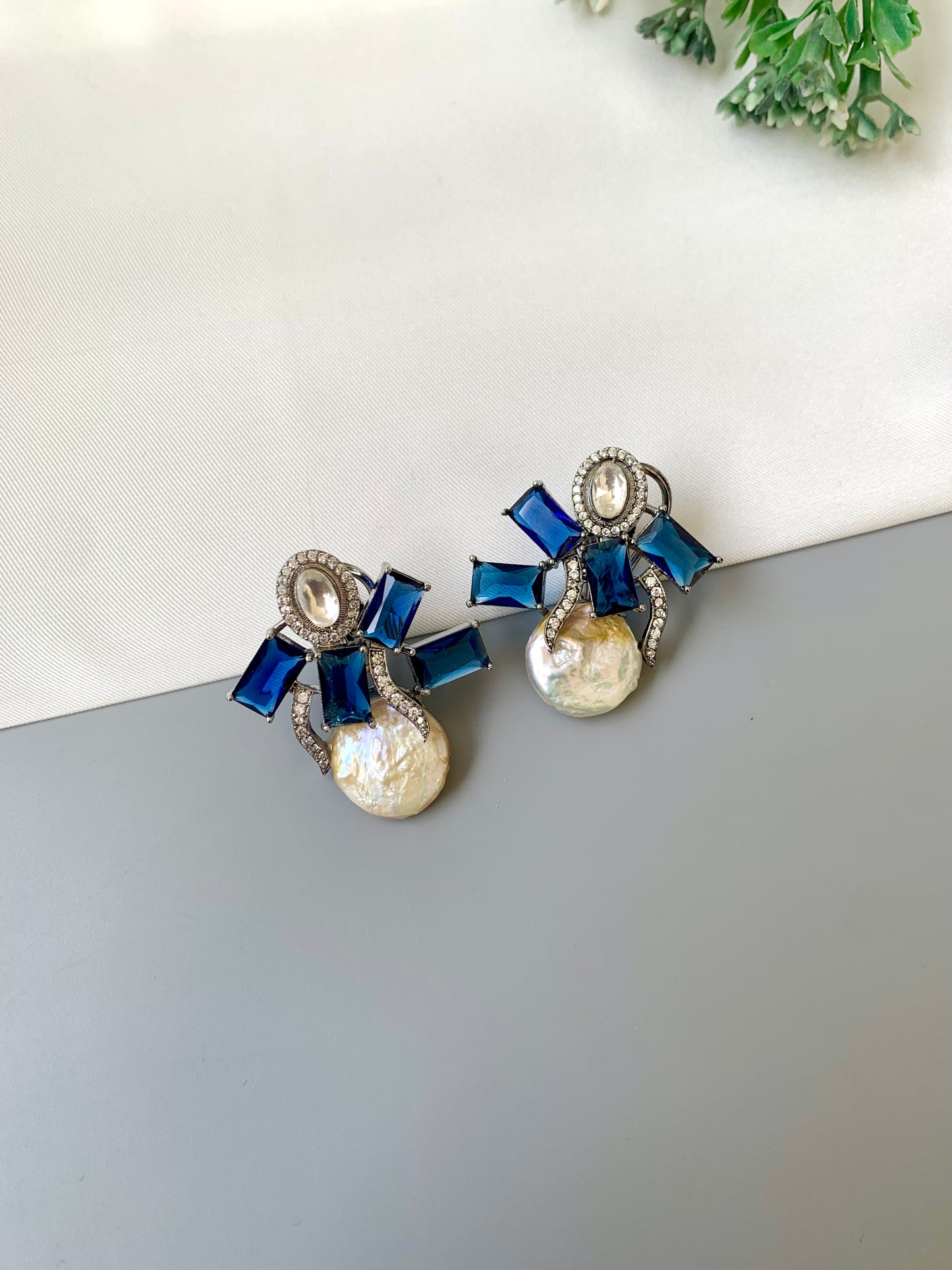 Klara sapphire polki kundan studs in rhodium oxidized finish with baroque pearls