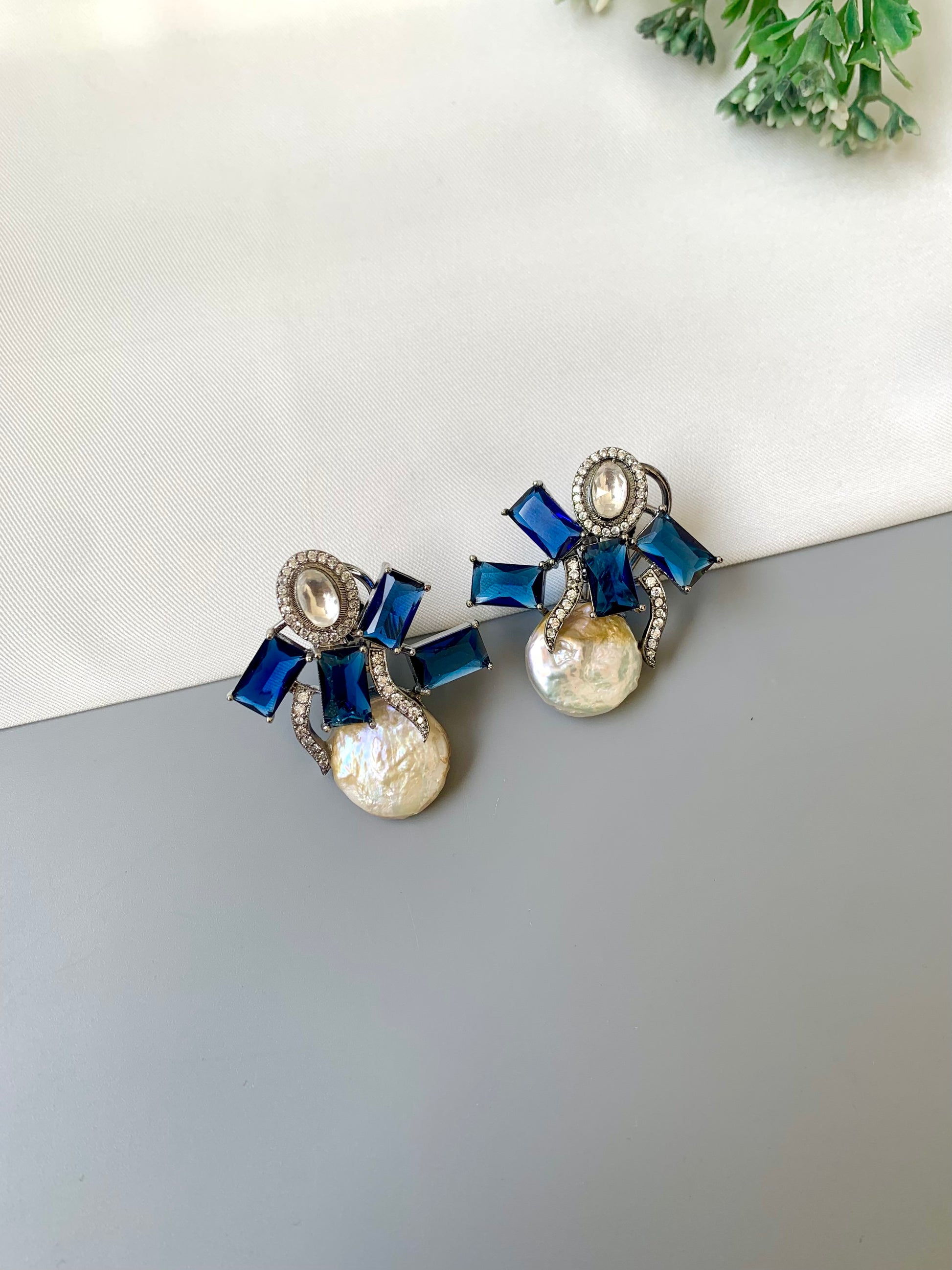 Klara sapphire polki kundan studs in rhodium oxidized finish with baroque pearls