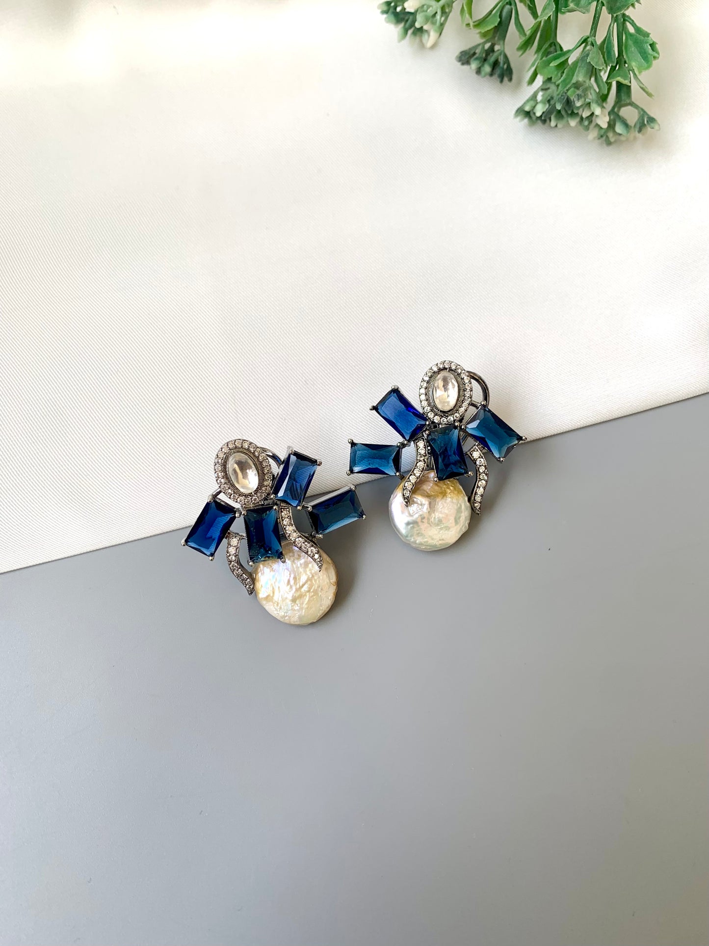 Klara sapphire polki kundan studs in rhodium oxidized finish with baroque pearls