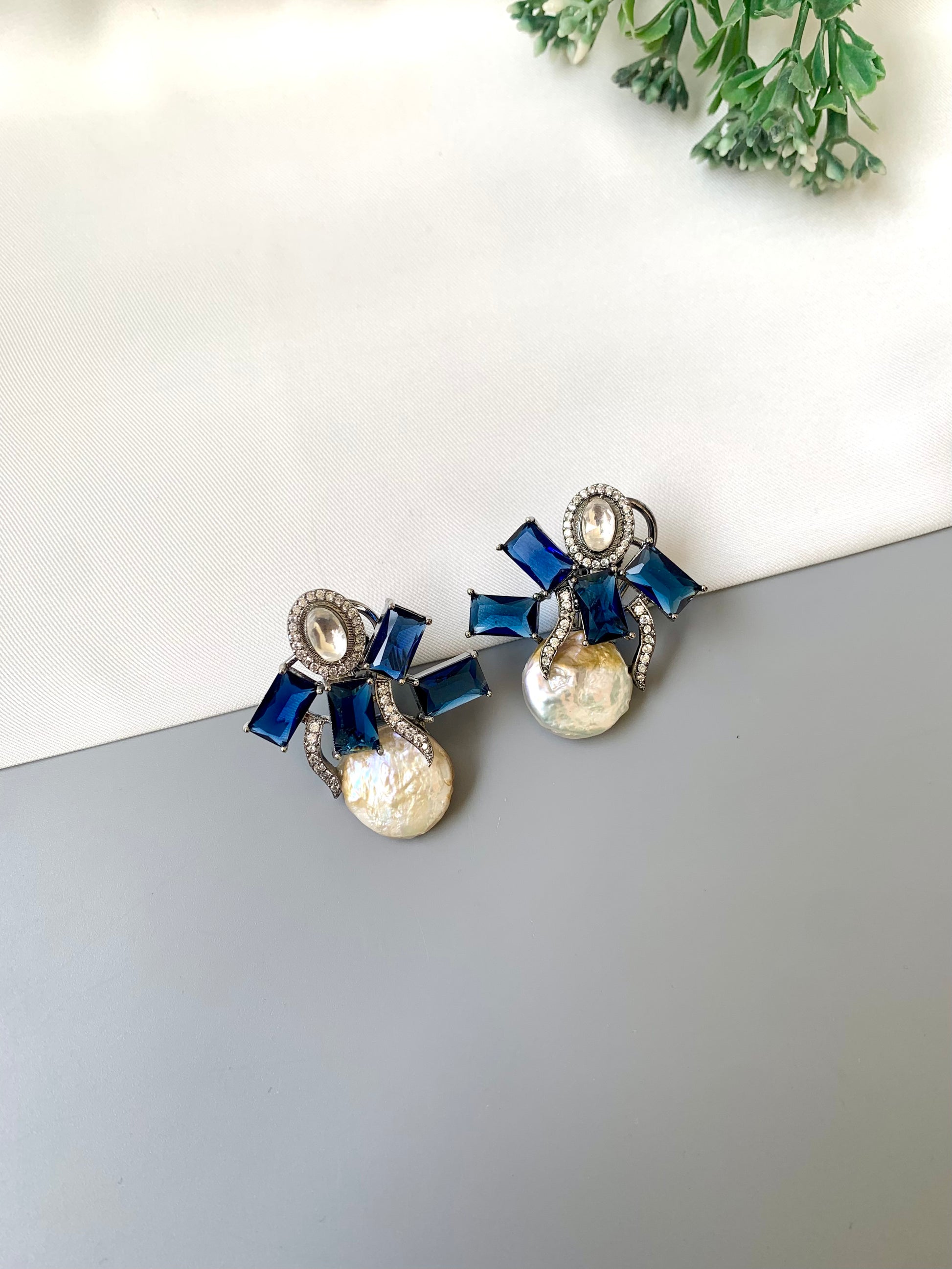 Klara sapphire polki kundan studs in rhodium oxidized finish with baroque pearls