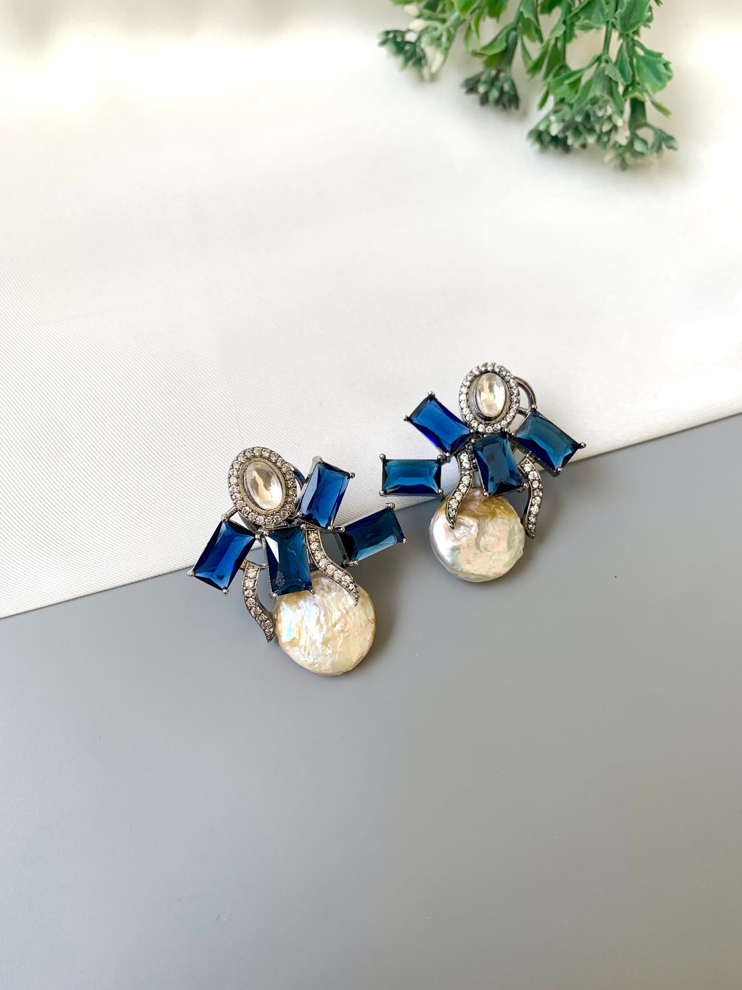 Klara sapphire polki kundan studs in rhodium oxidized finish with baroque pearls
